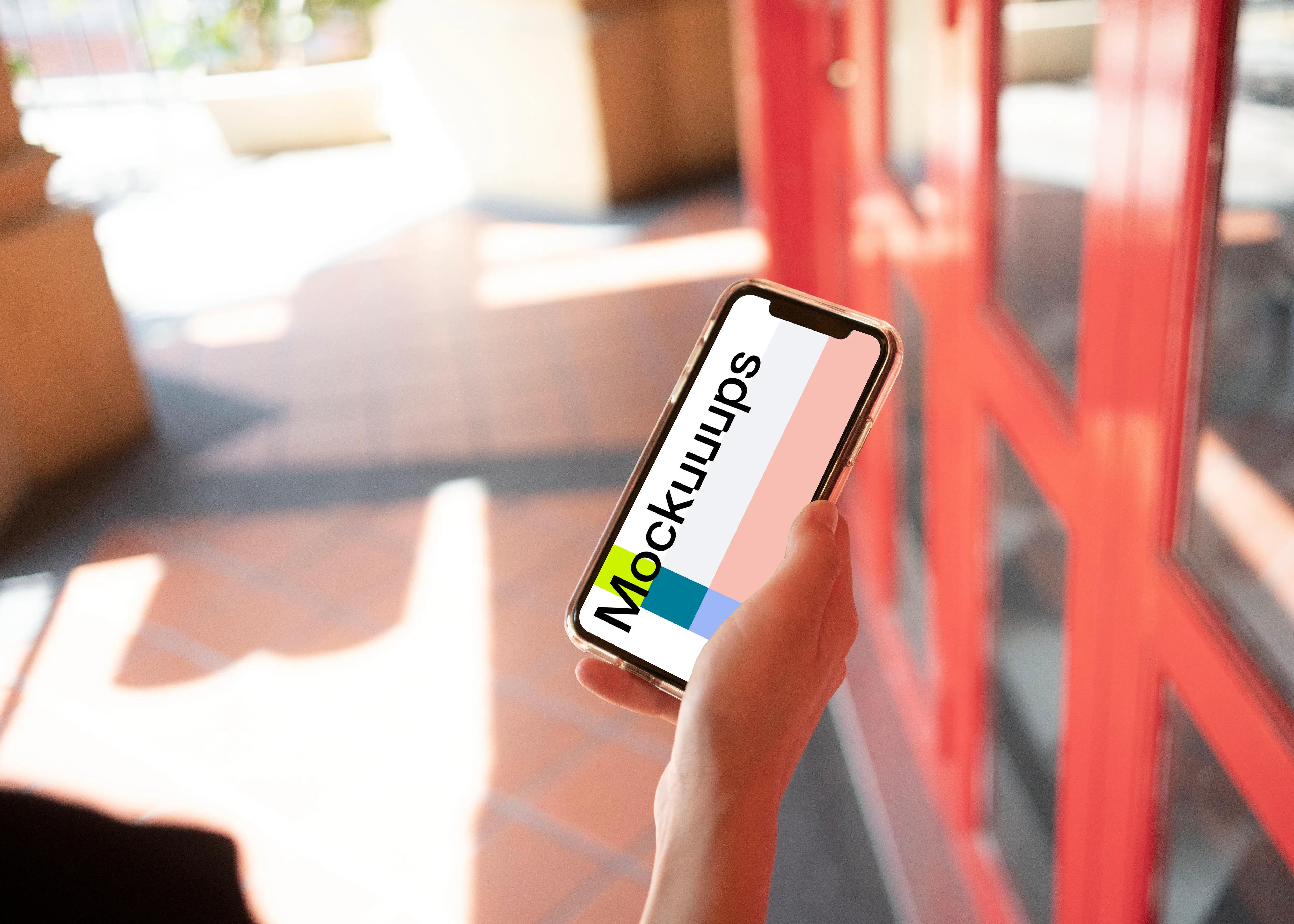 iPhone mockup held near red door.