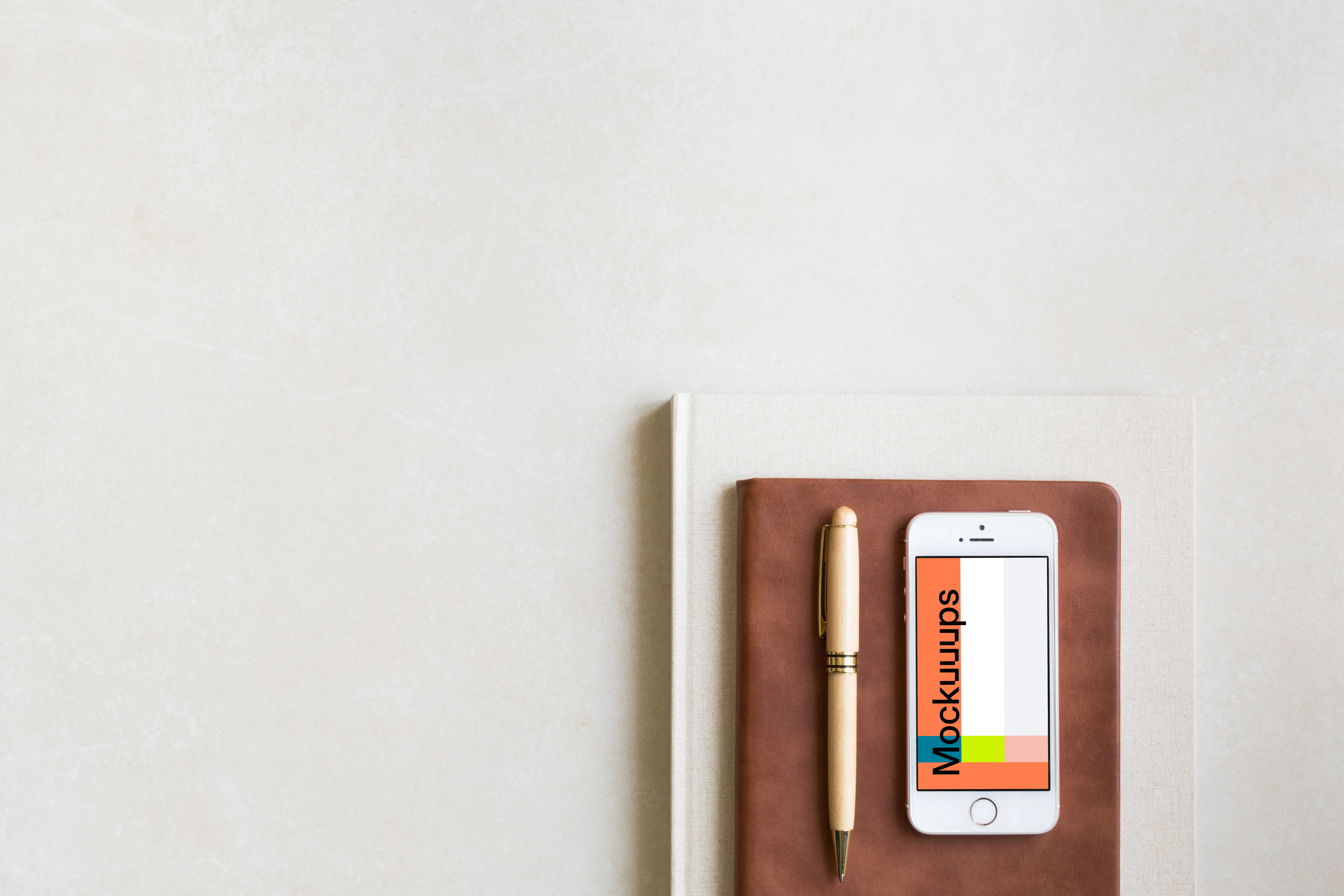 iPhone SE mockup placed on leather journal