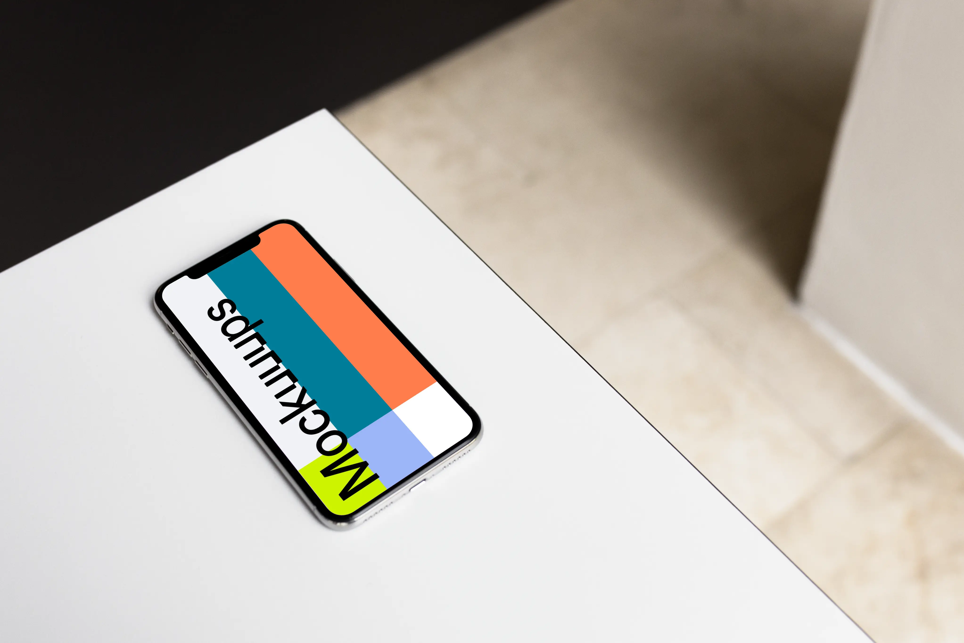 iPhone X mockup on the gray table