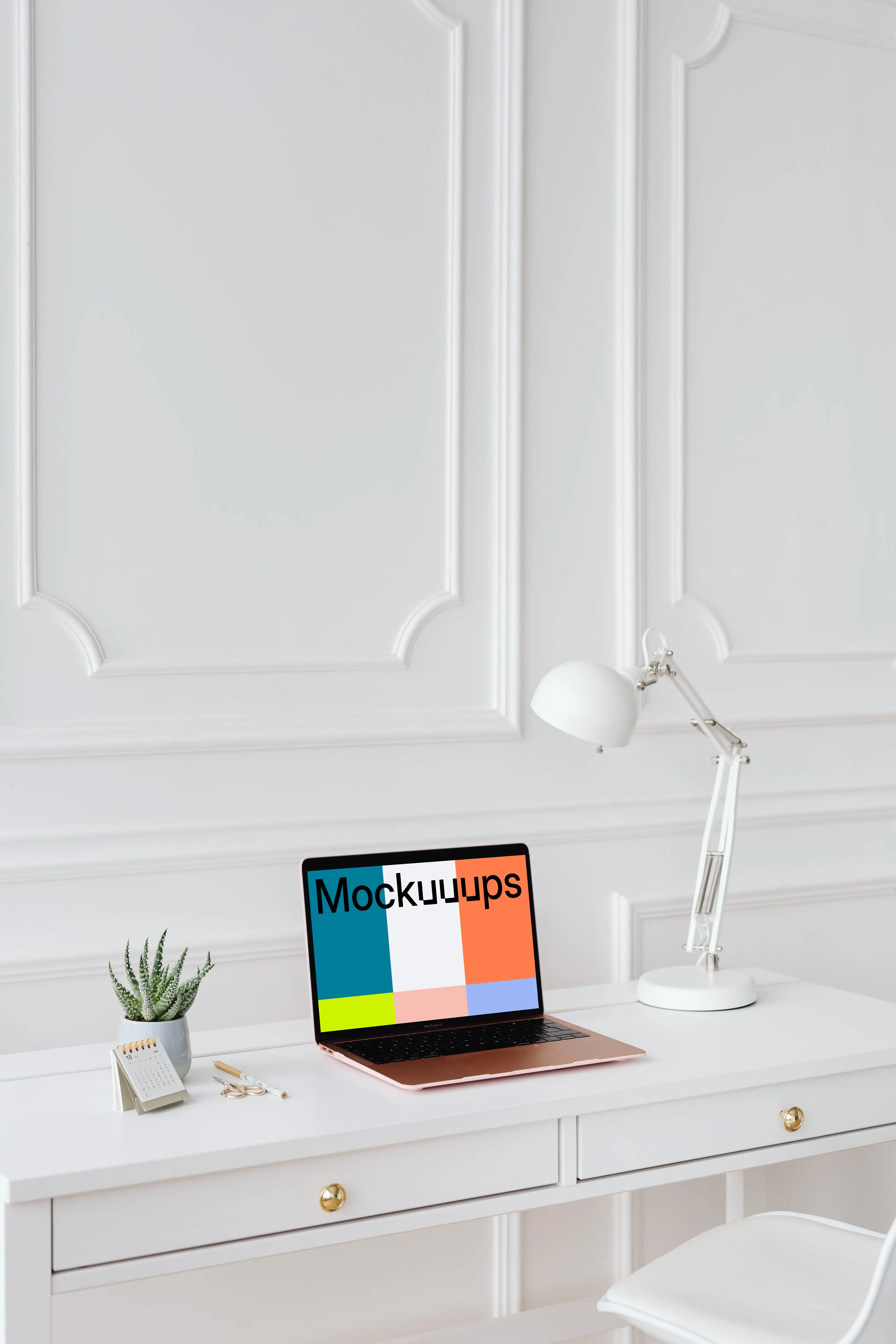 MacBook Air mockup on a desk beside a potted plant