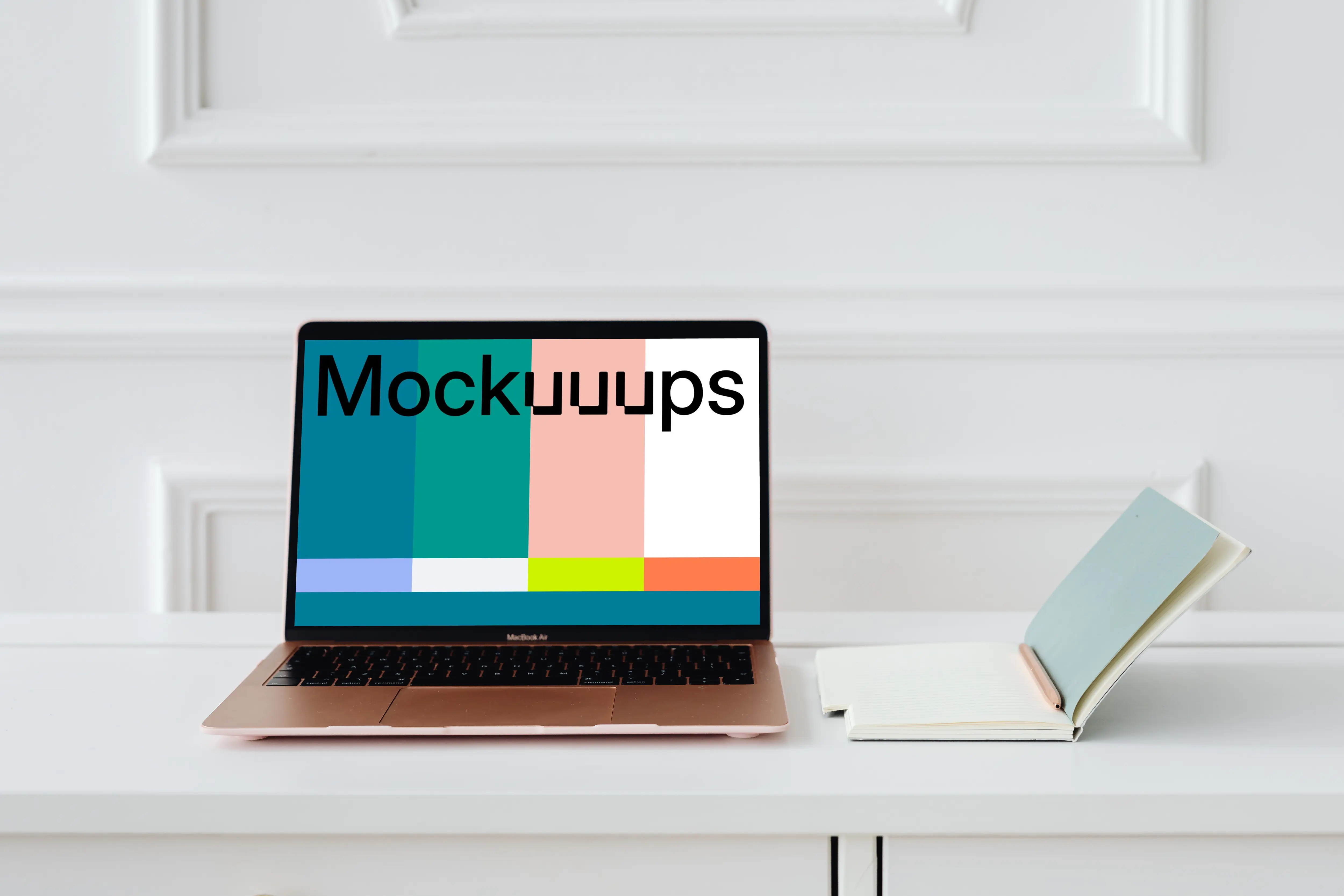 MacBook Air mockup on a table beside a notepad and a pencil