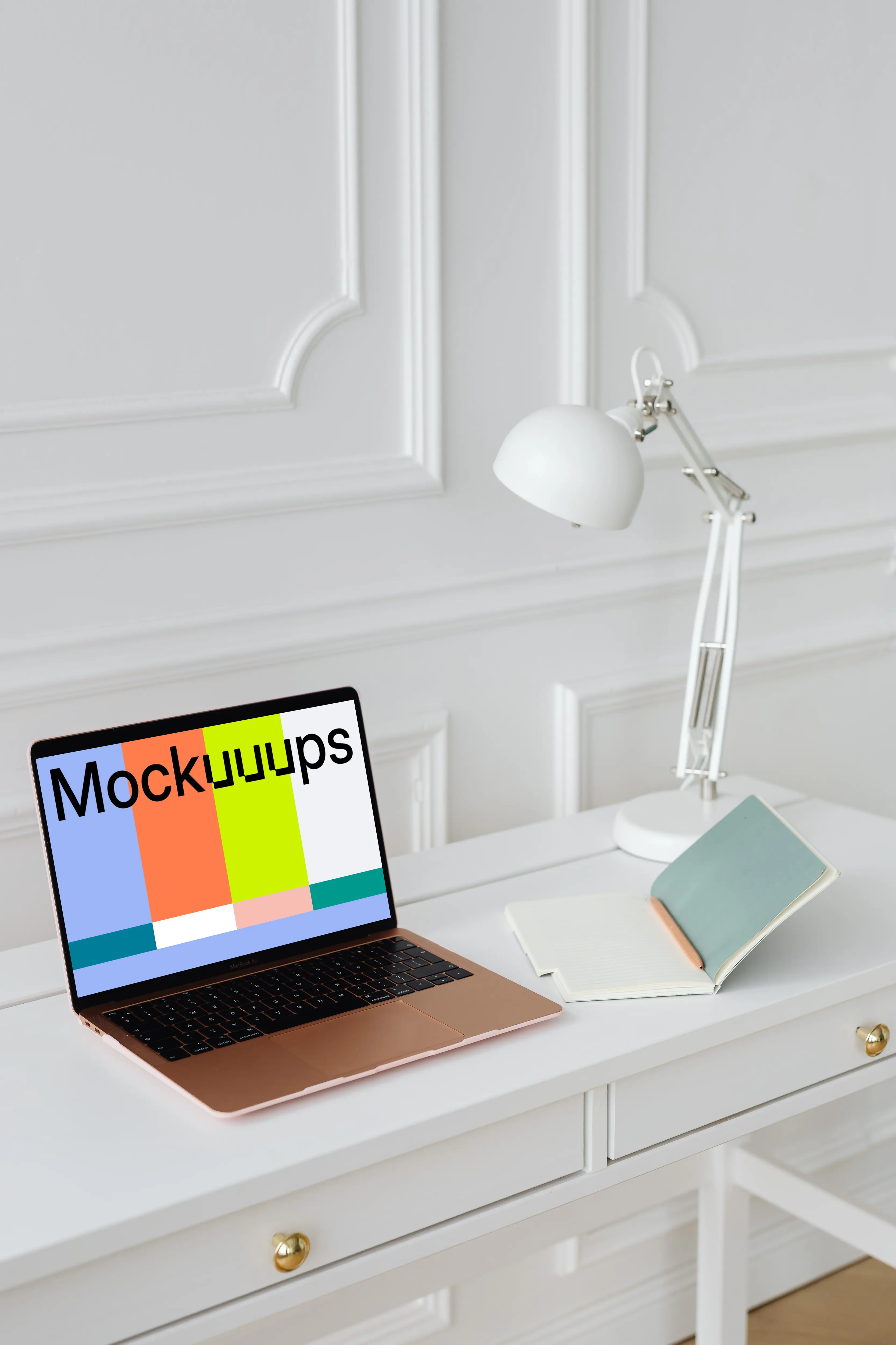 MacBook Air mockup on a table beside an open notepad  