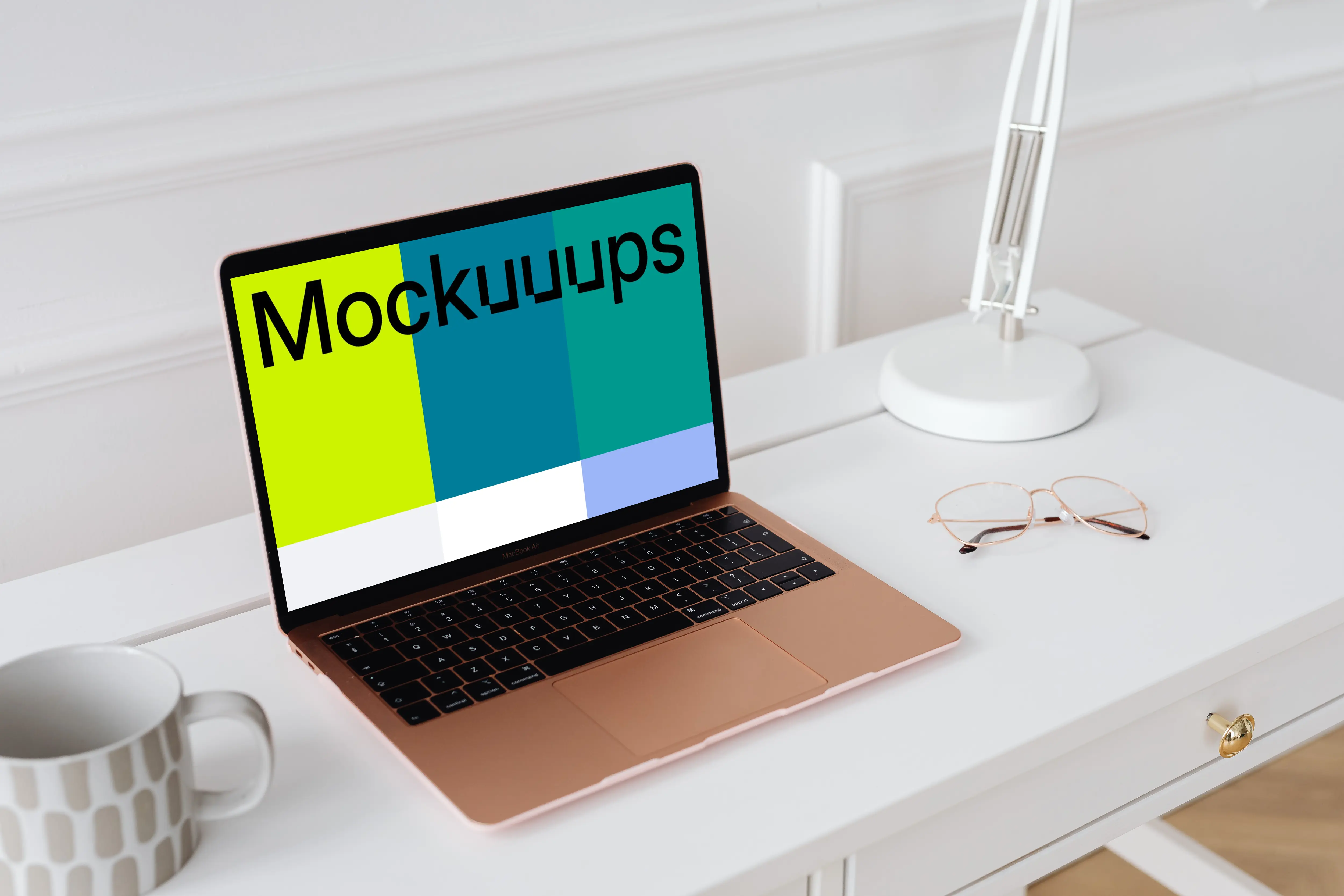 MacBook Air mockup on a table with a coffee mug at the side