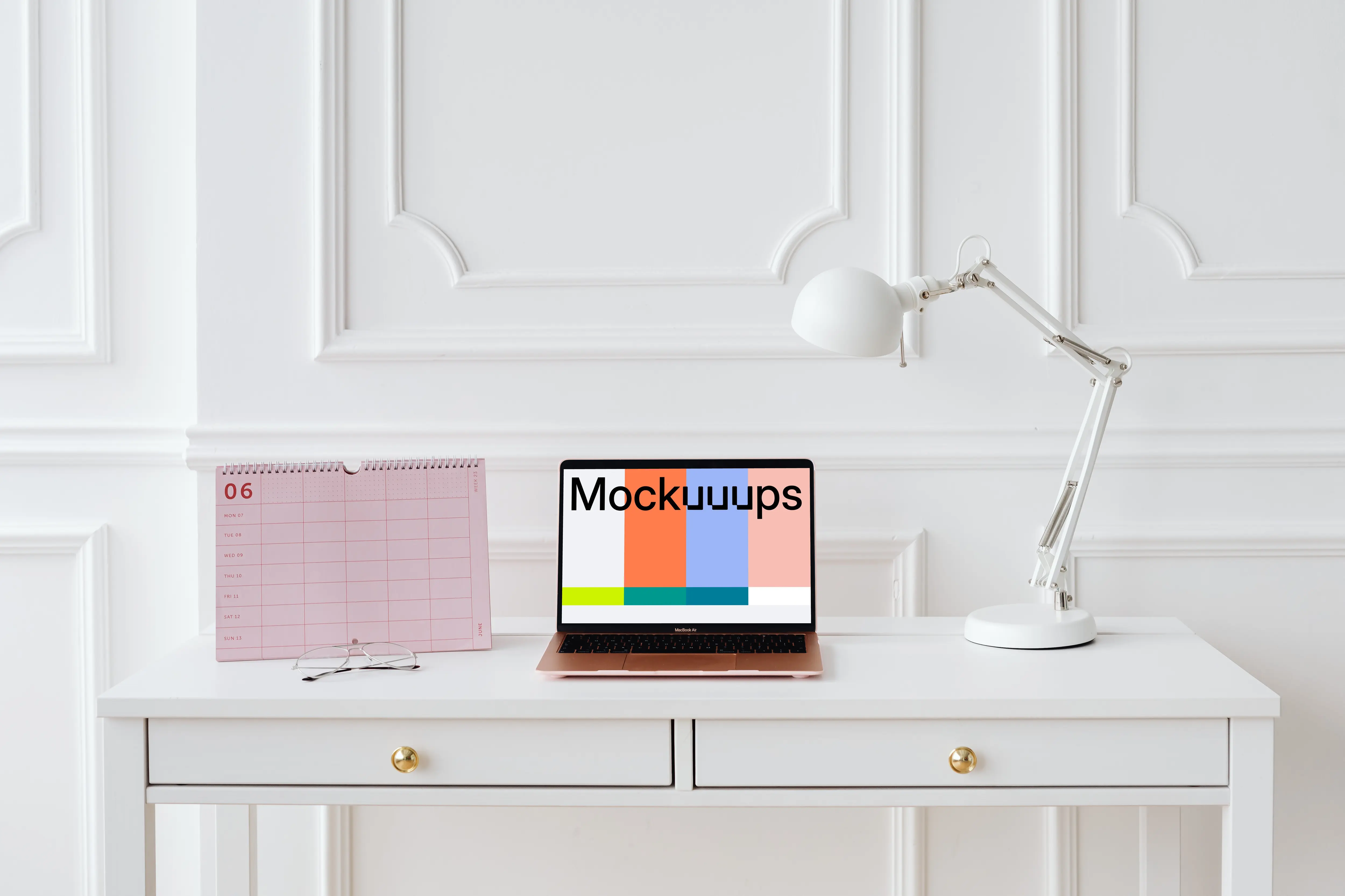 MacBook Air mockup on a table with a pink calendar at the side