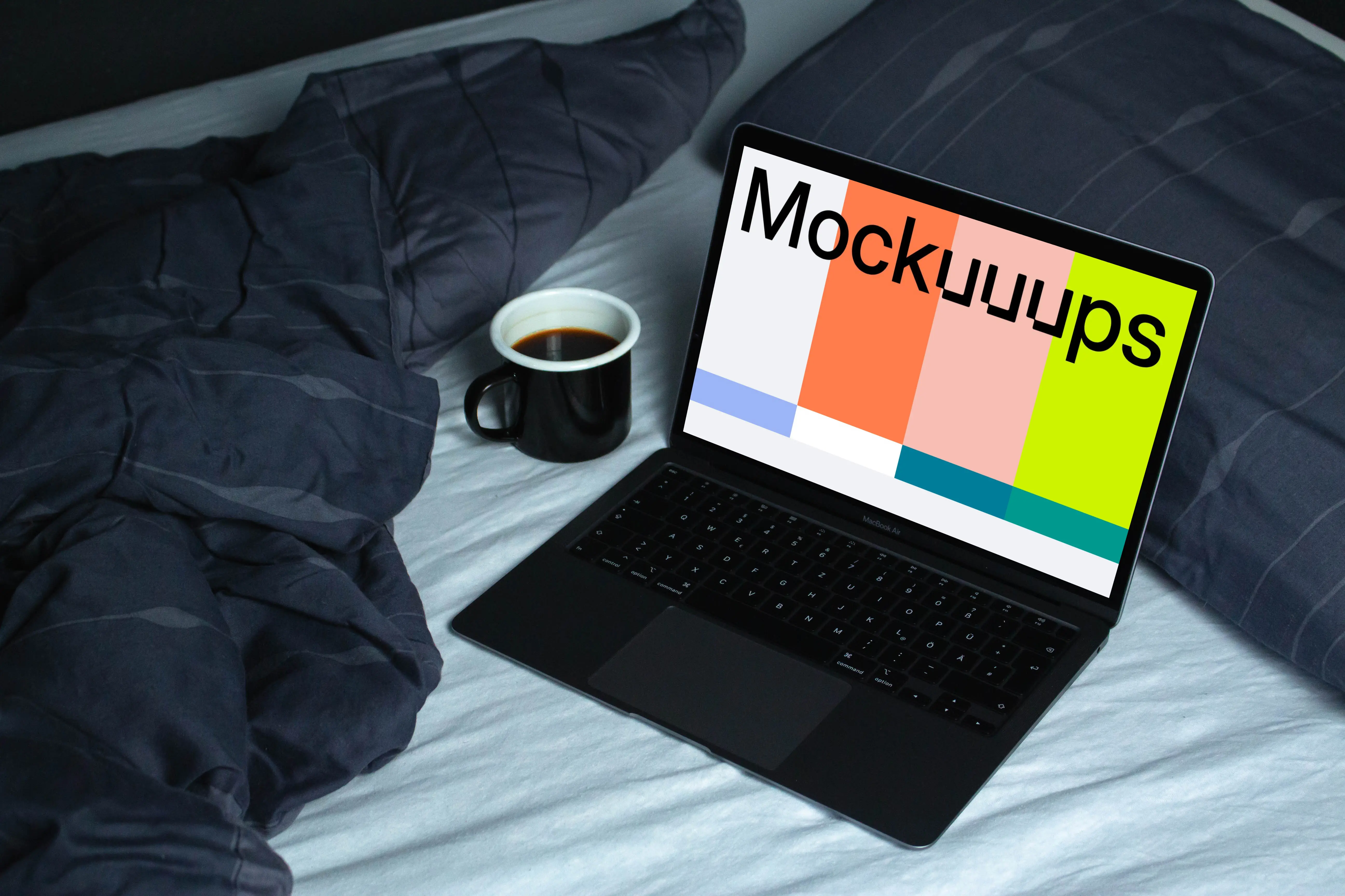 MacBook mockup on a white bed beside a cup of coffee and blue duvet 