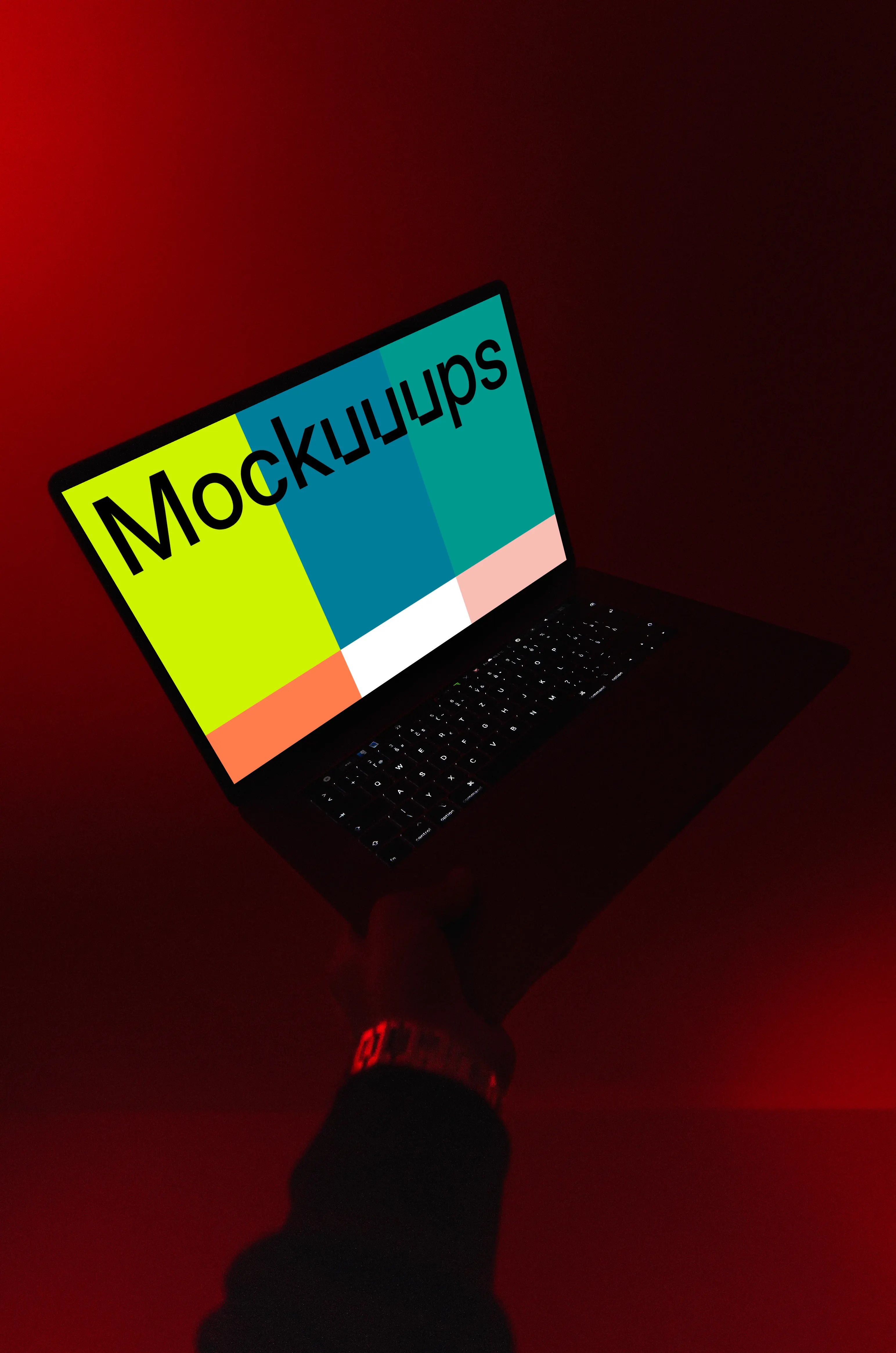 MacBook night mockup held under red light