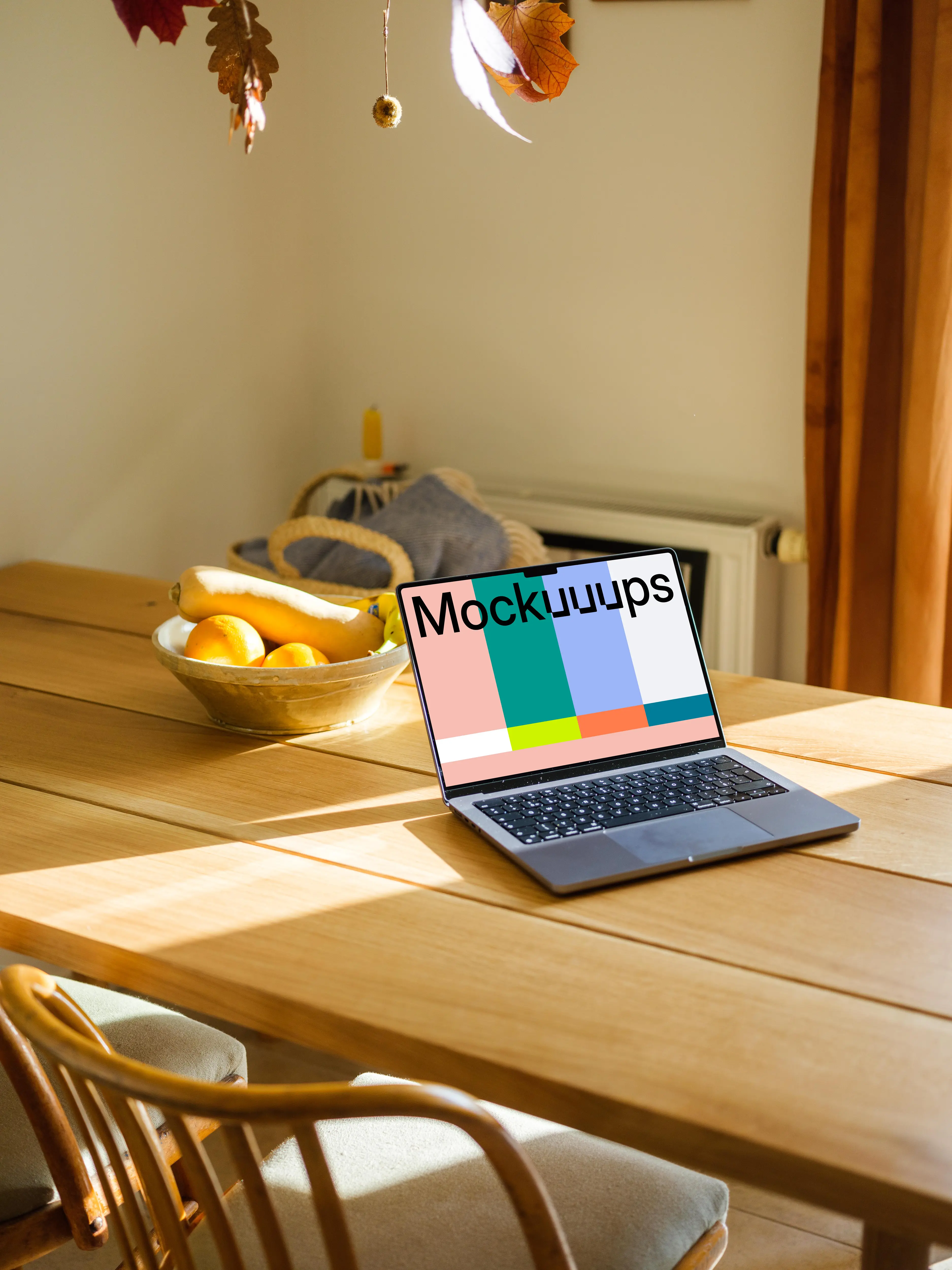MacBook Pro mockup on a table with photo frames in the background