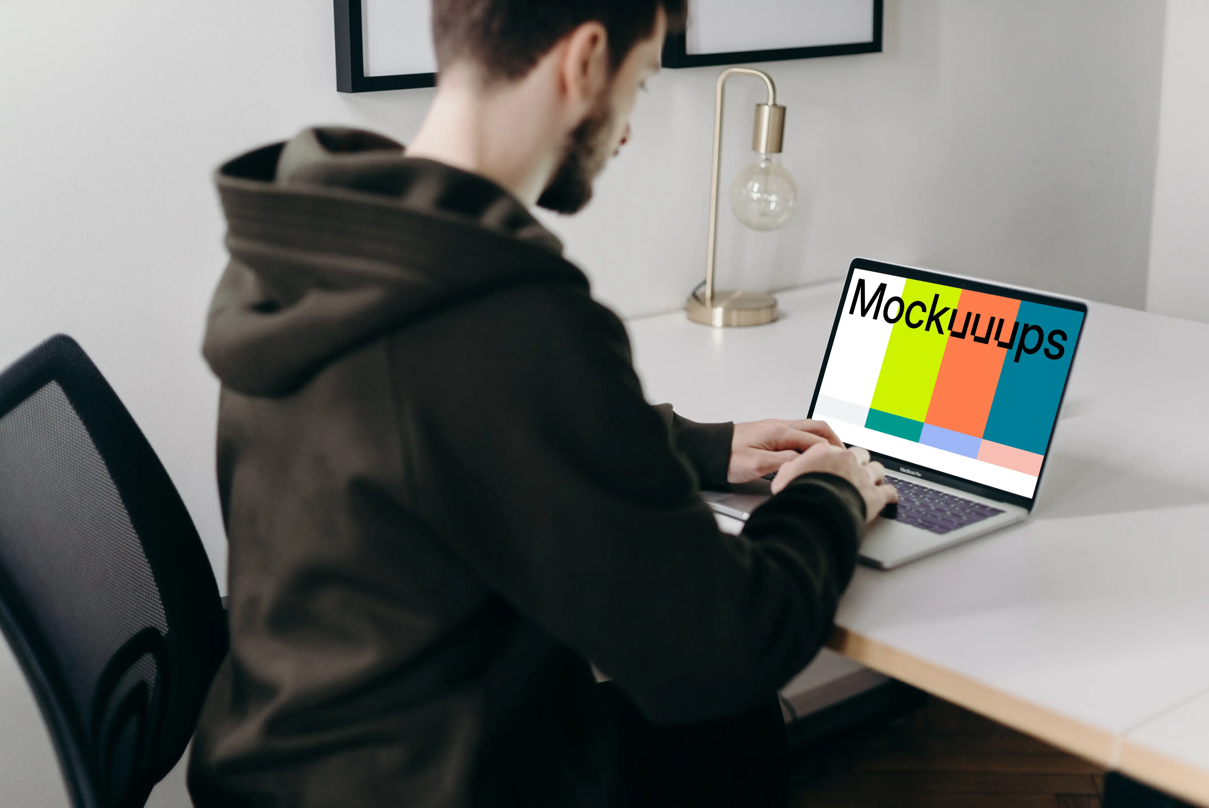 MacBook Pro mockup on a white table close to a lamp