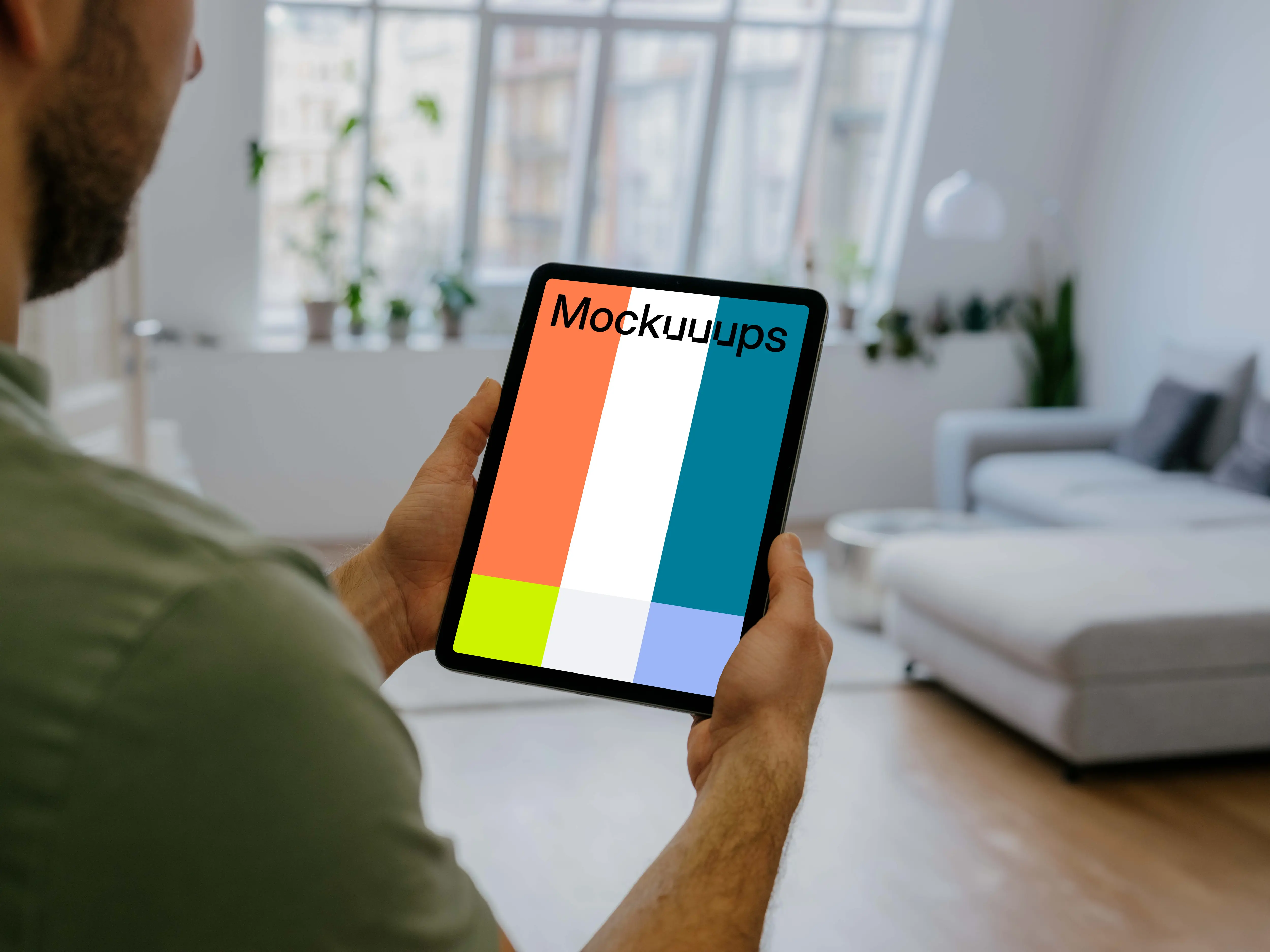 Man holding up an iPad Air mockup