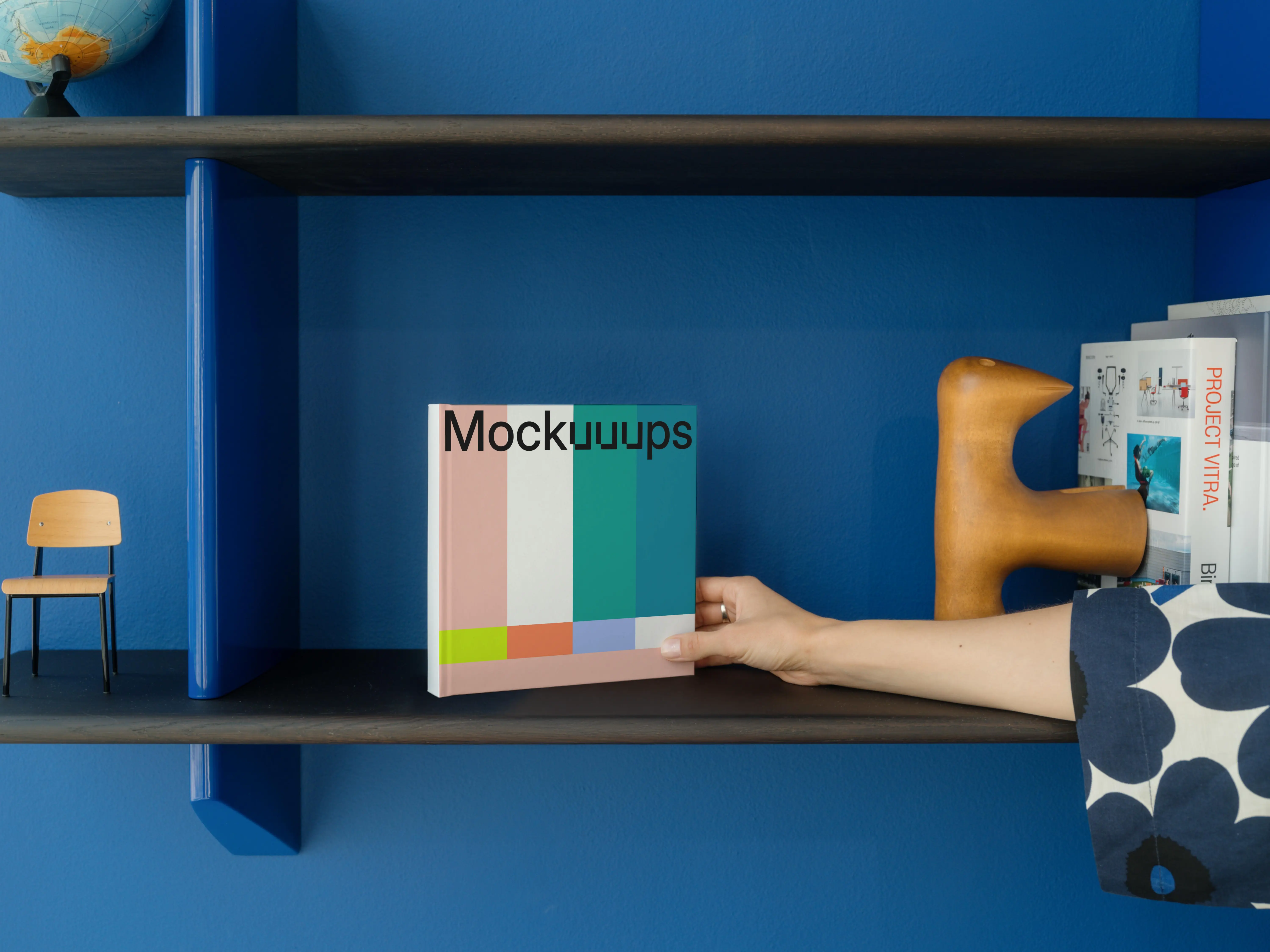 Mockup of a square book on a colorful shelf