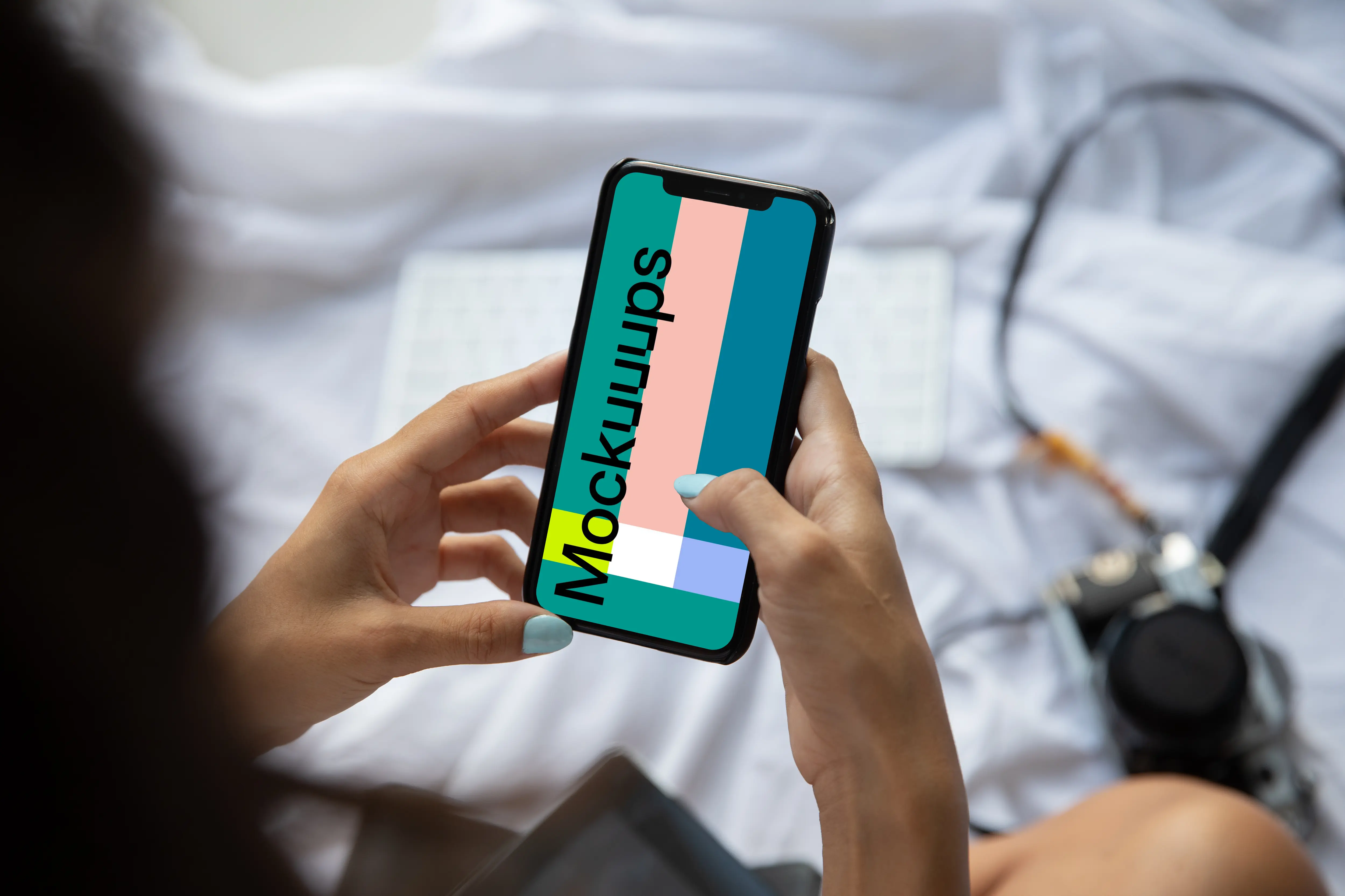 Mockup of lady holding an iPhone in bed