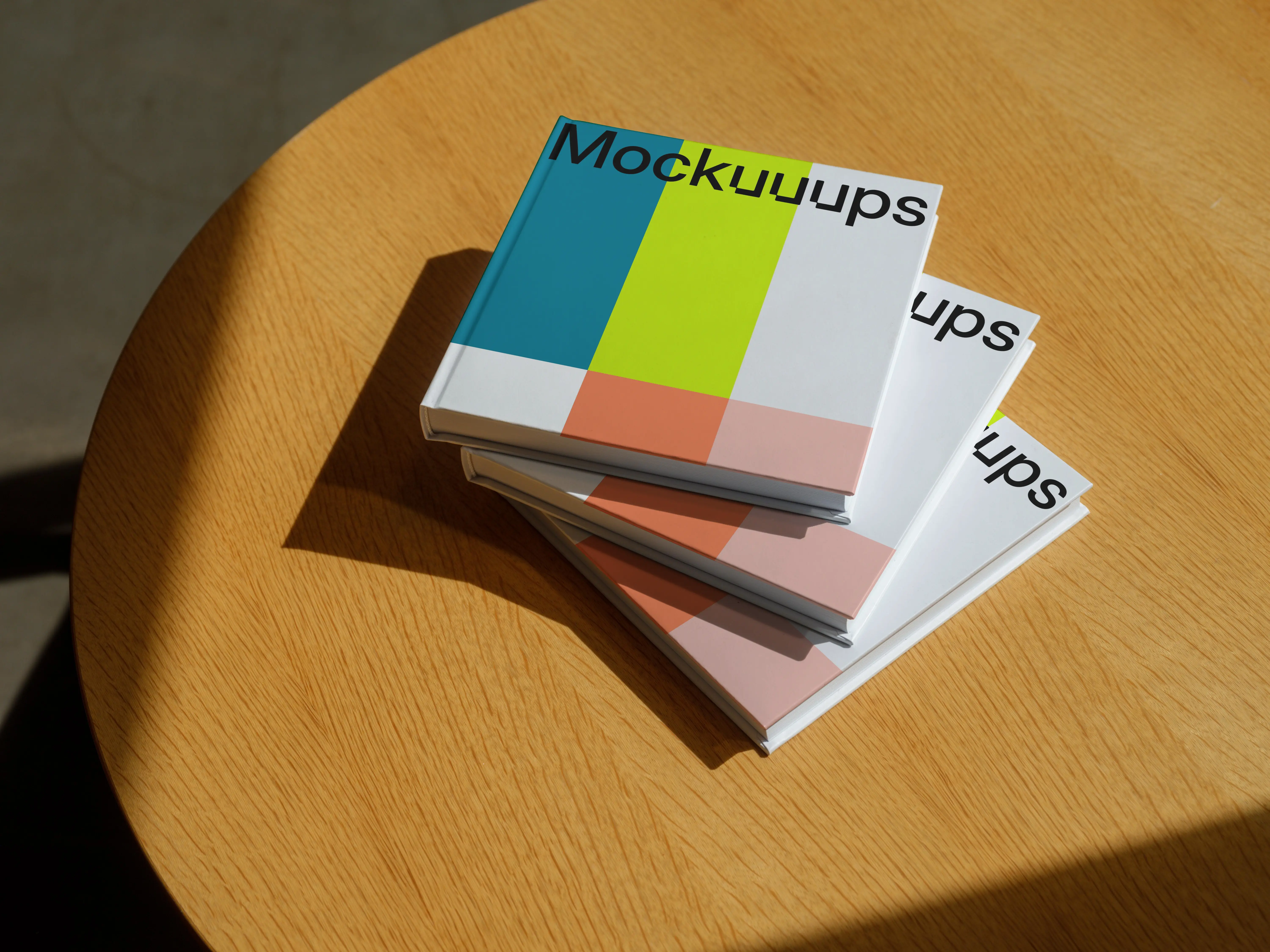 Mockup of stacked hardcover books on a wooden table