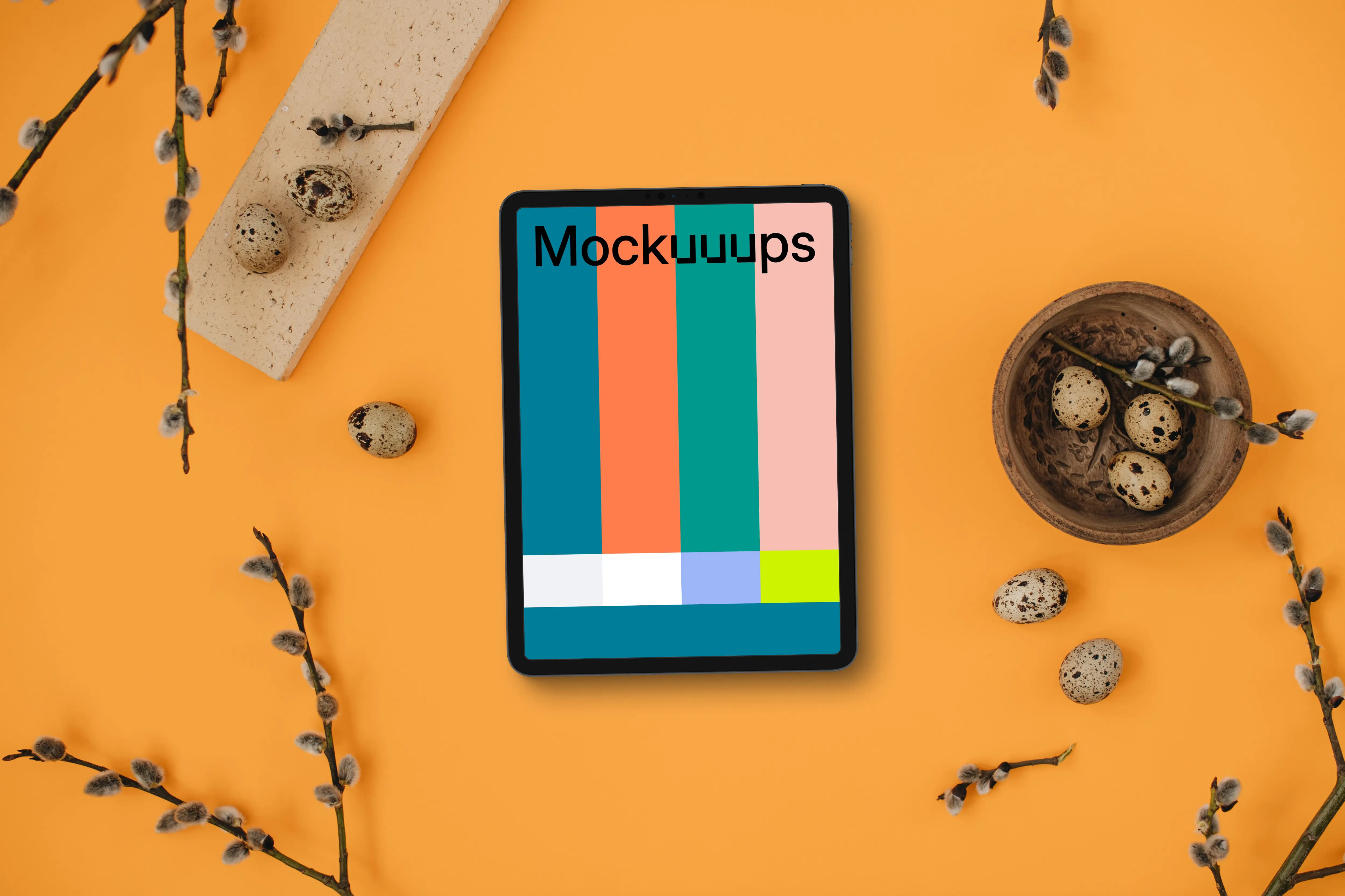 Orange table with a tablet mockup and Easter decorations