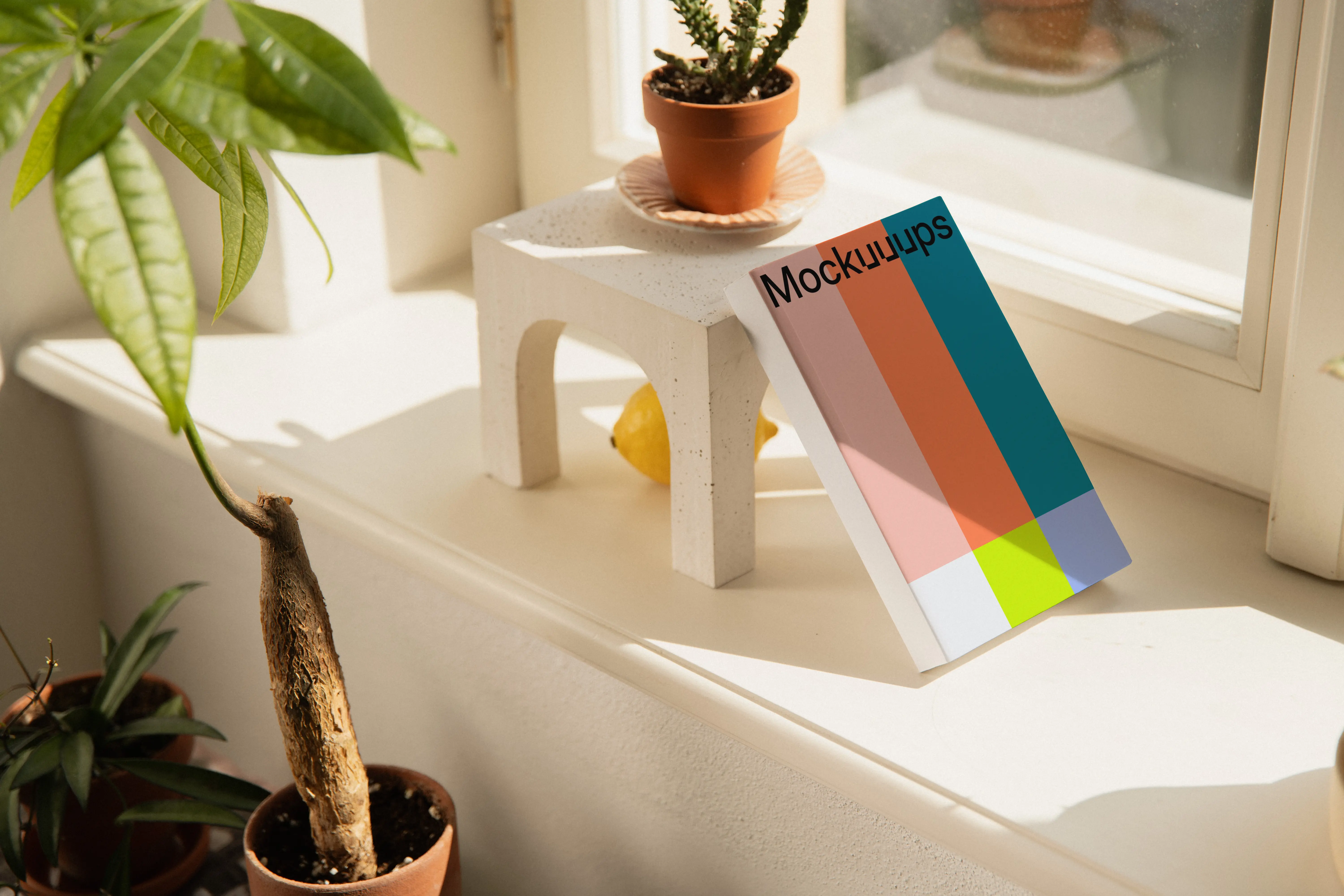 Paperback mockup on a sunny windowsill with plants