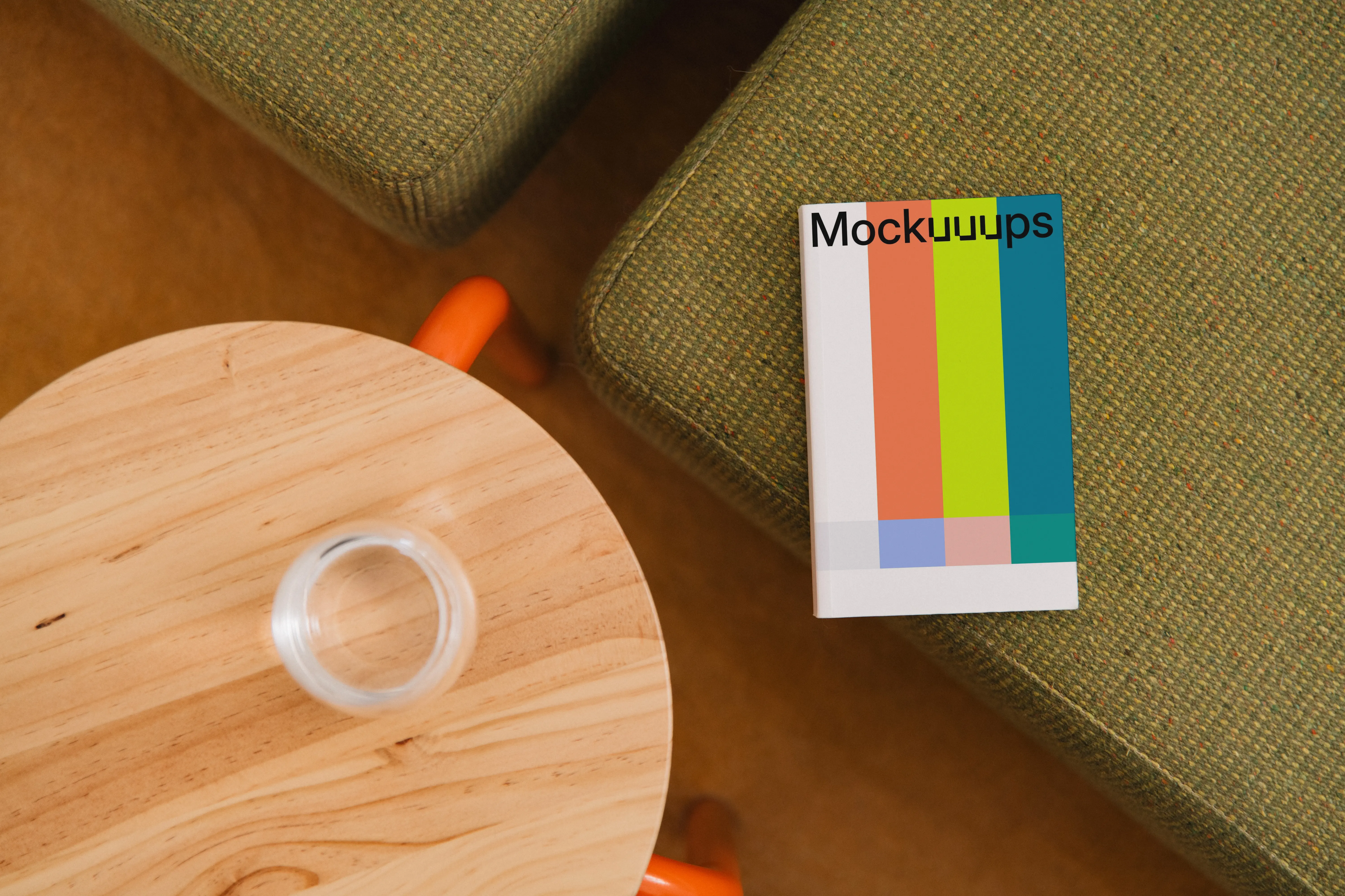Paperback mockup on a textured sofa and wooden table