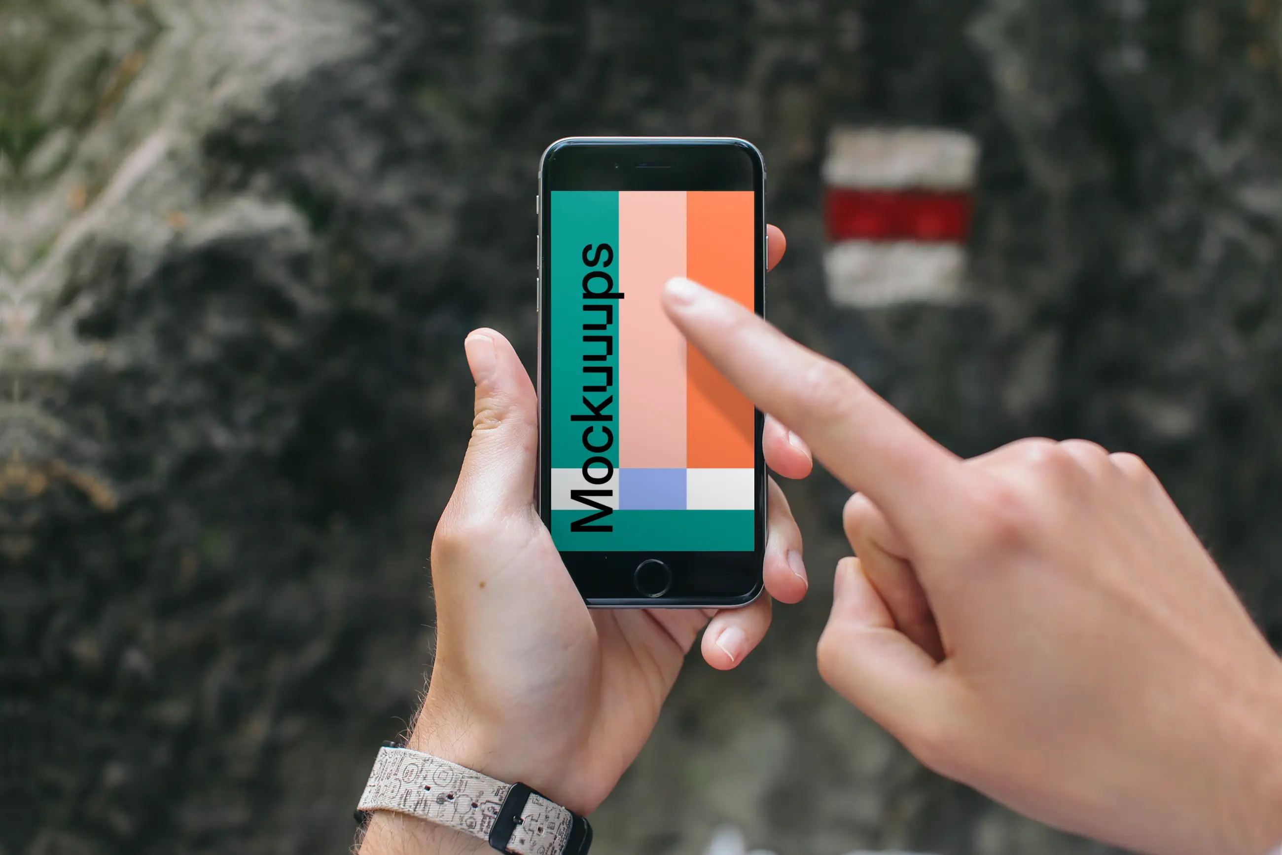 Pointing on iPhone 6 mockup in mountains