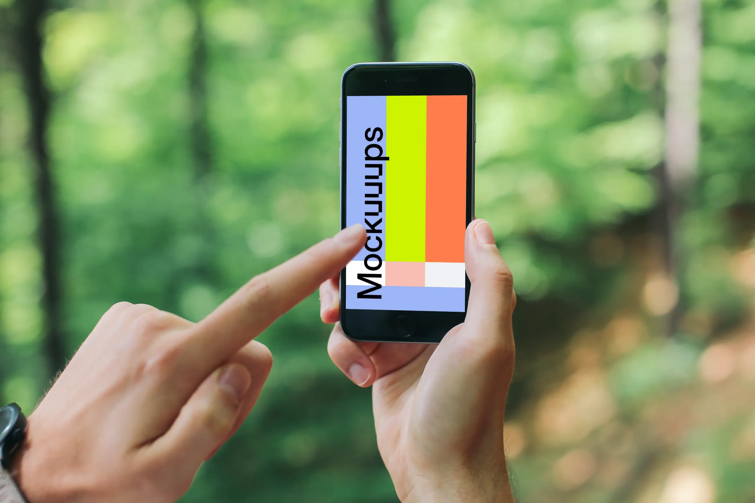 Pointing on iPhone 6 mockup in the forest