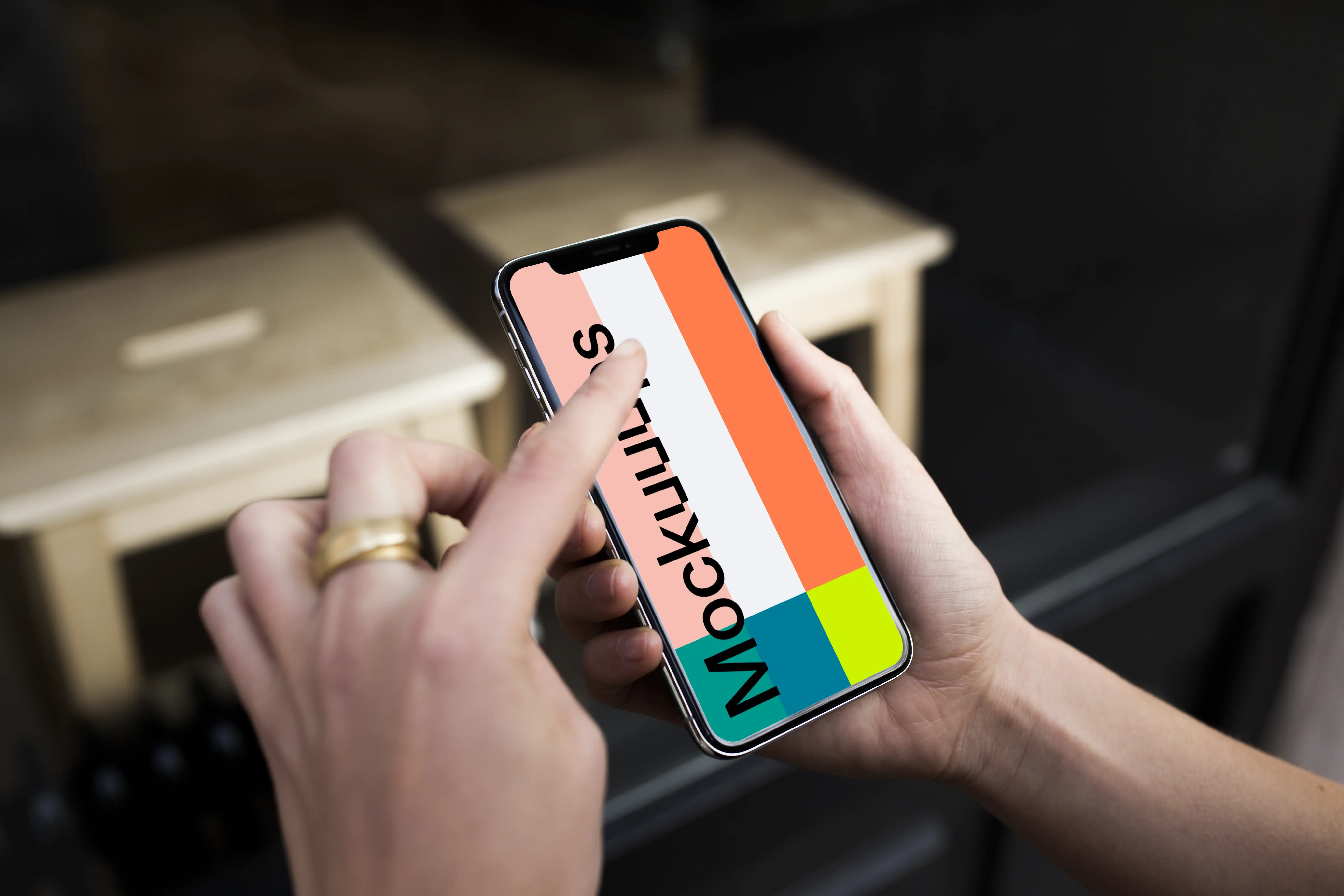 Pointing on iPhone X mockup in front of the shop
