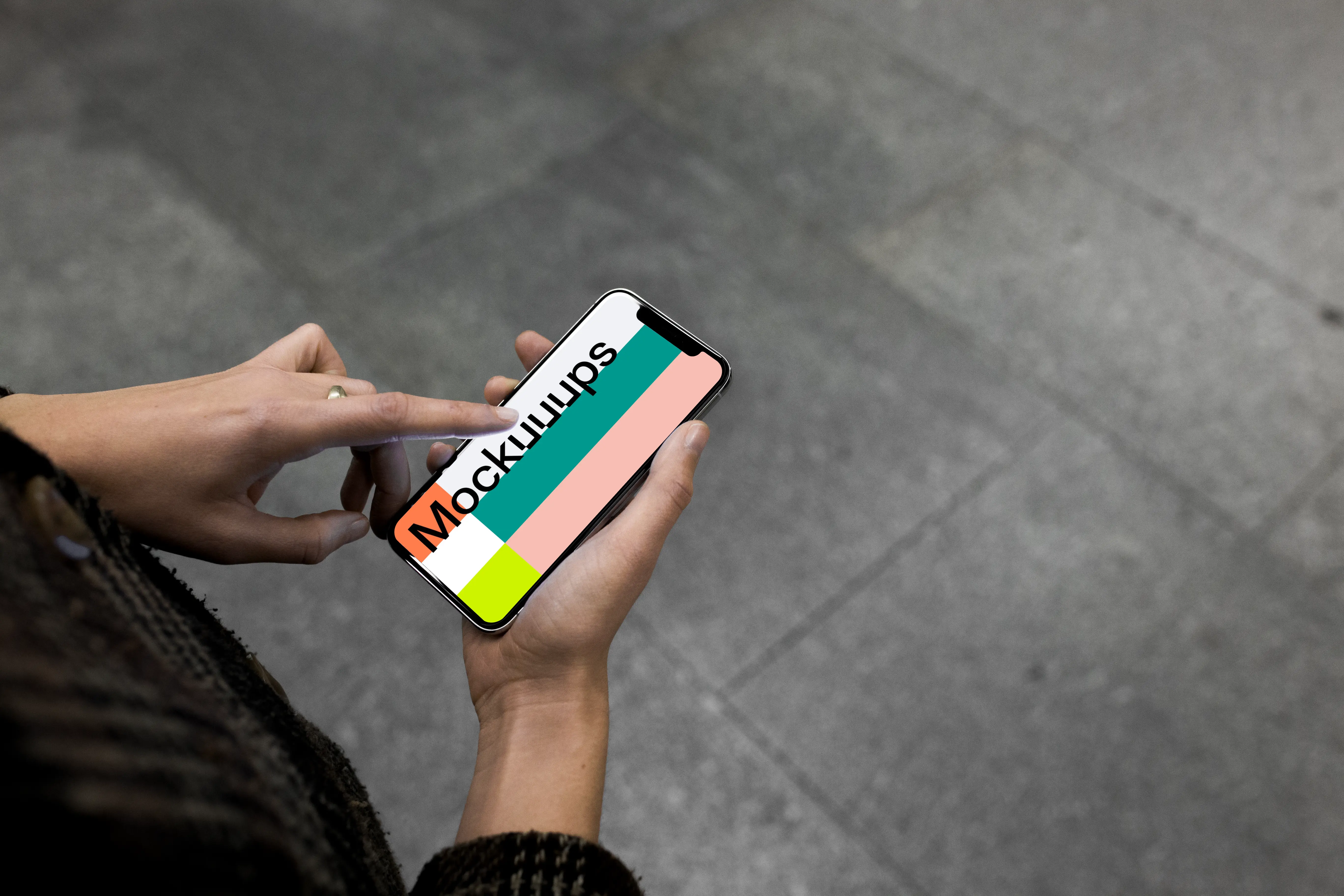 Pointing on iPhone X mockup in the underground