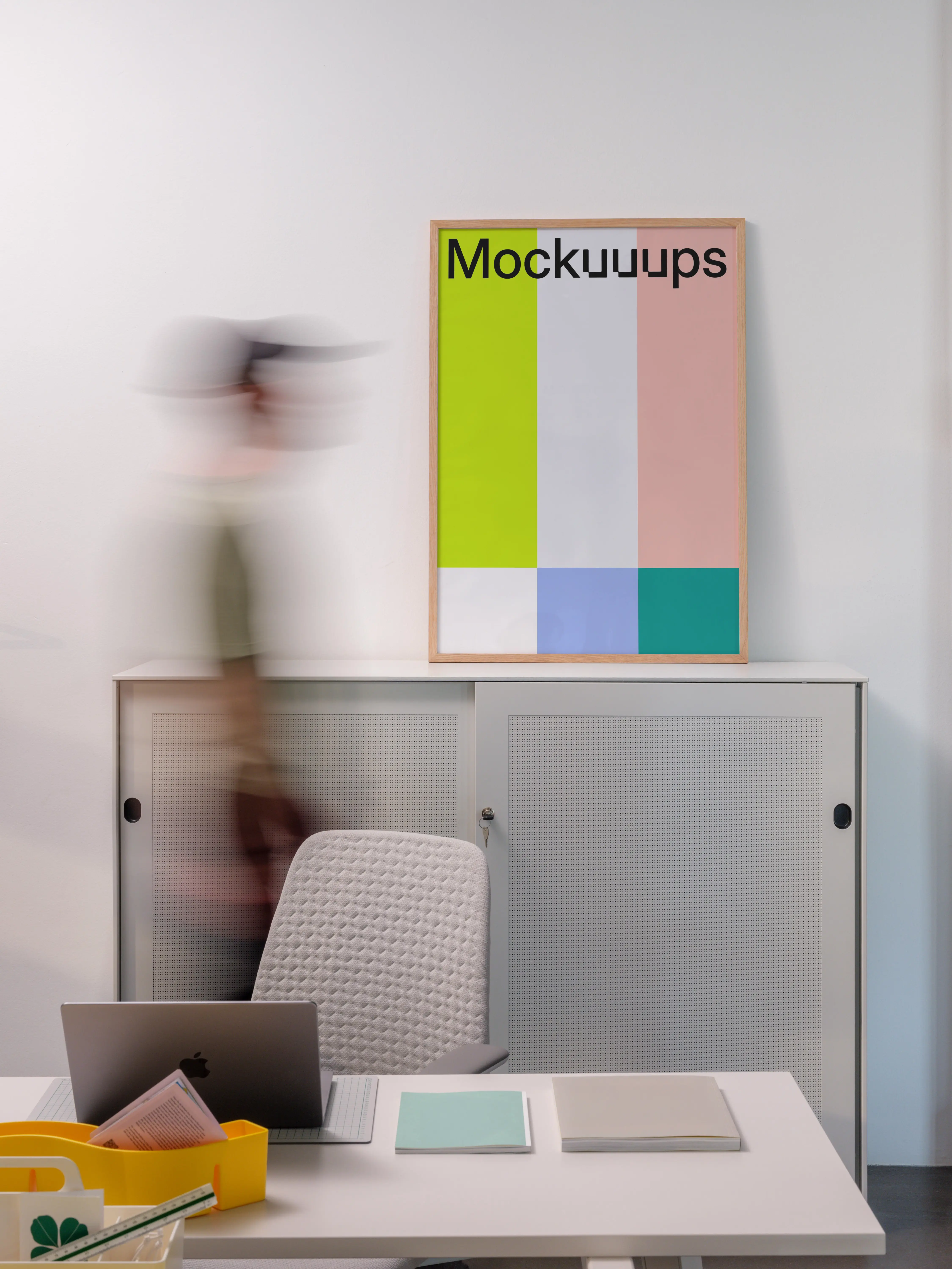 Poster mockup above a minimalist office cabinet