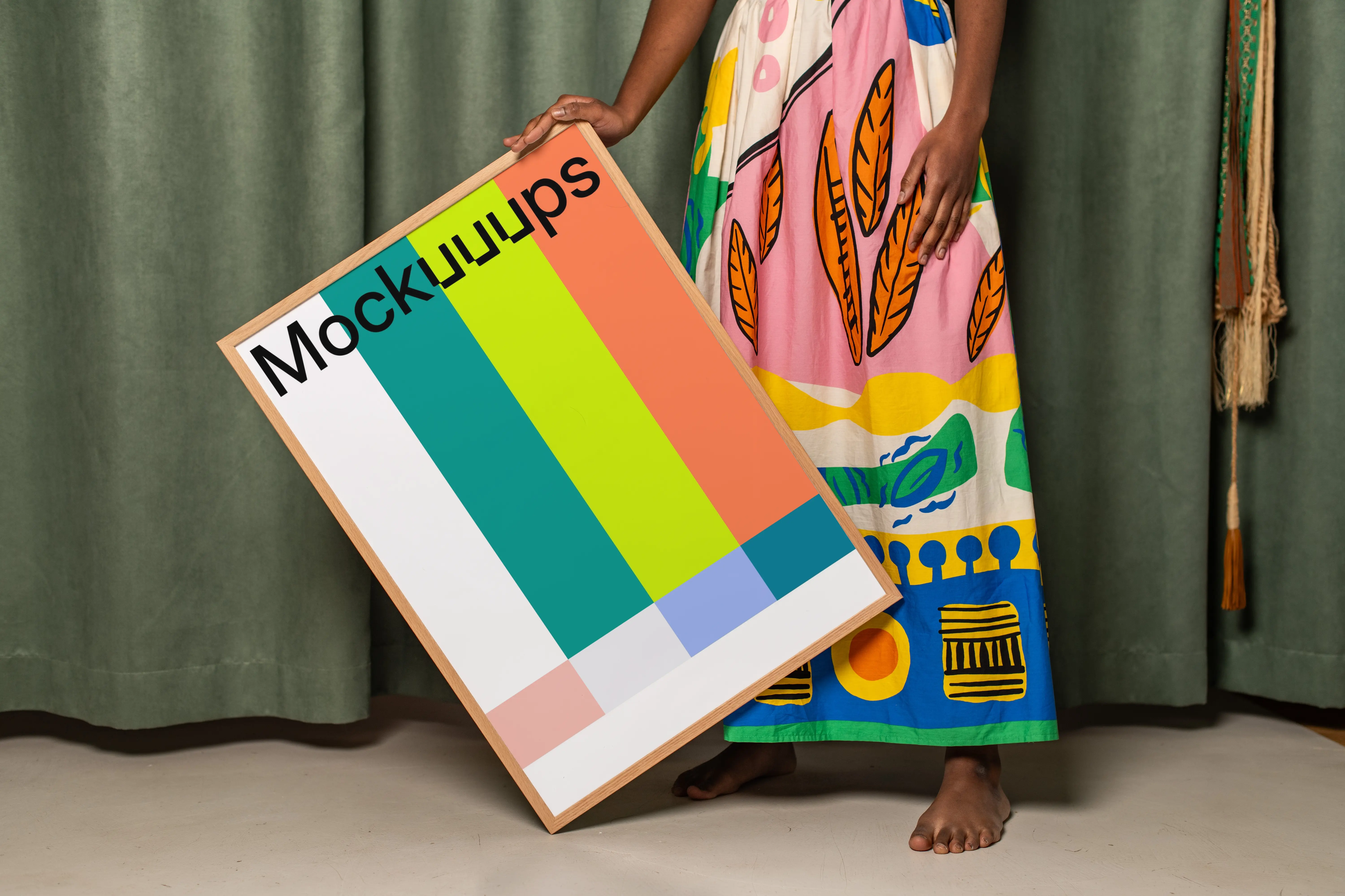 Poster mockup held against a colorful fabric backdrop