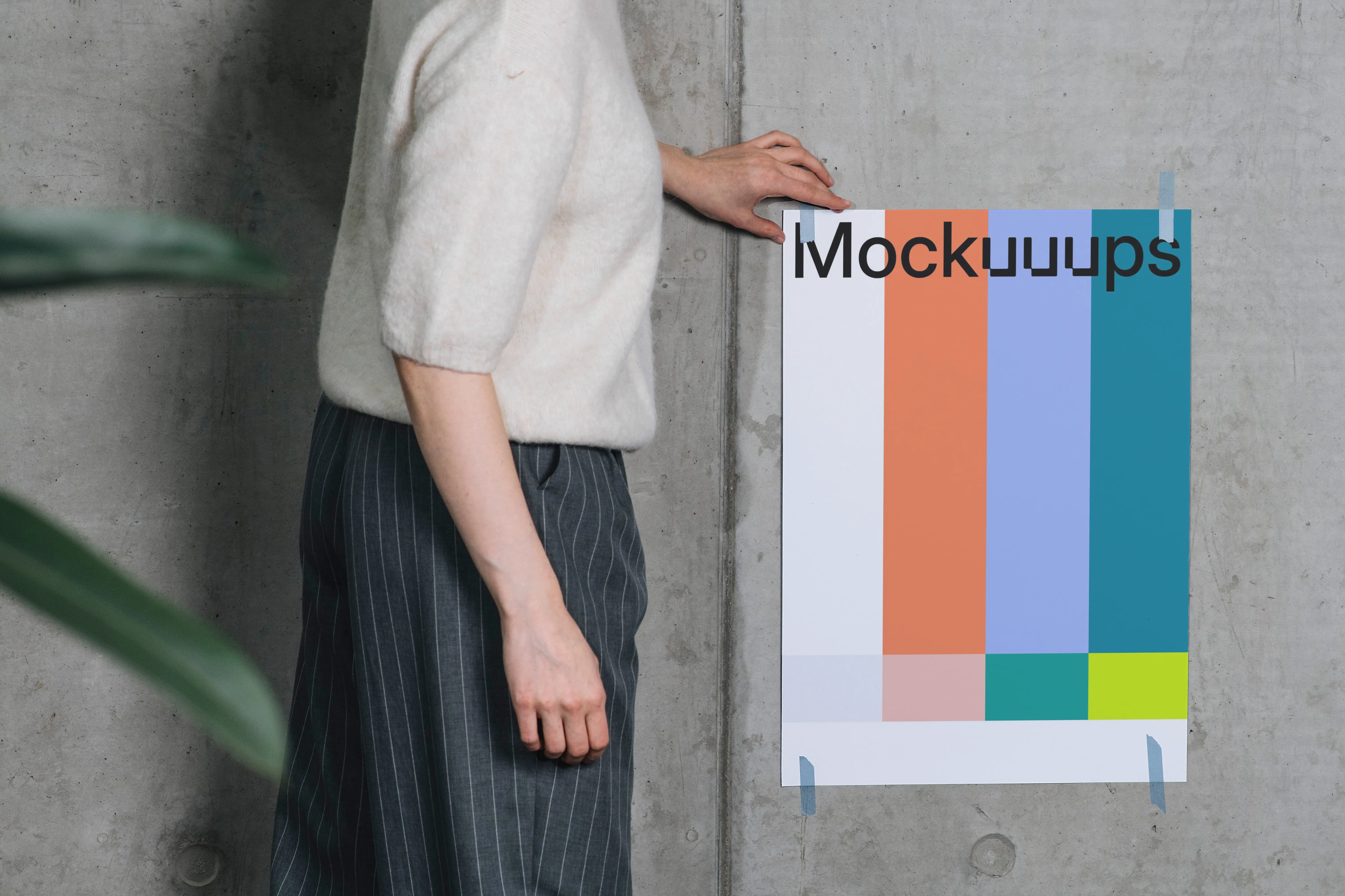 Poster mockup taped to a concrete wall with person