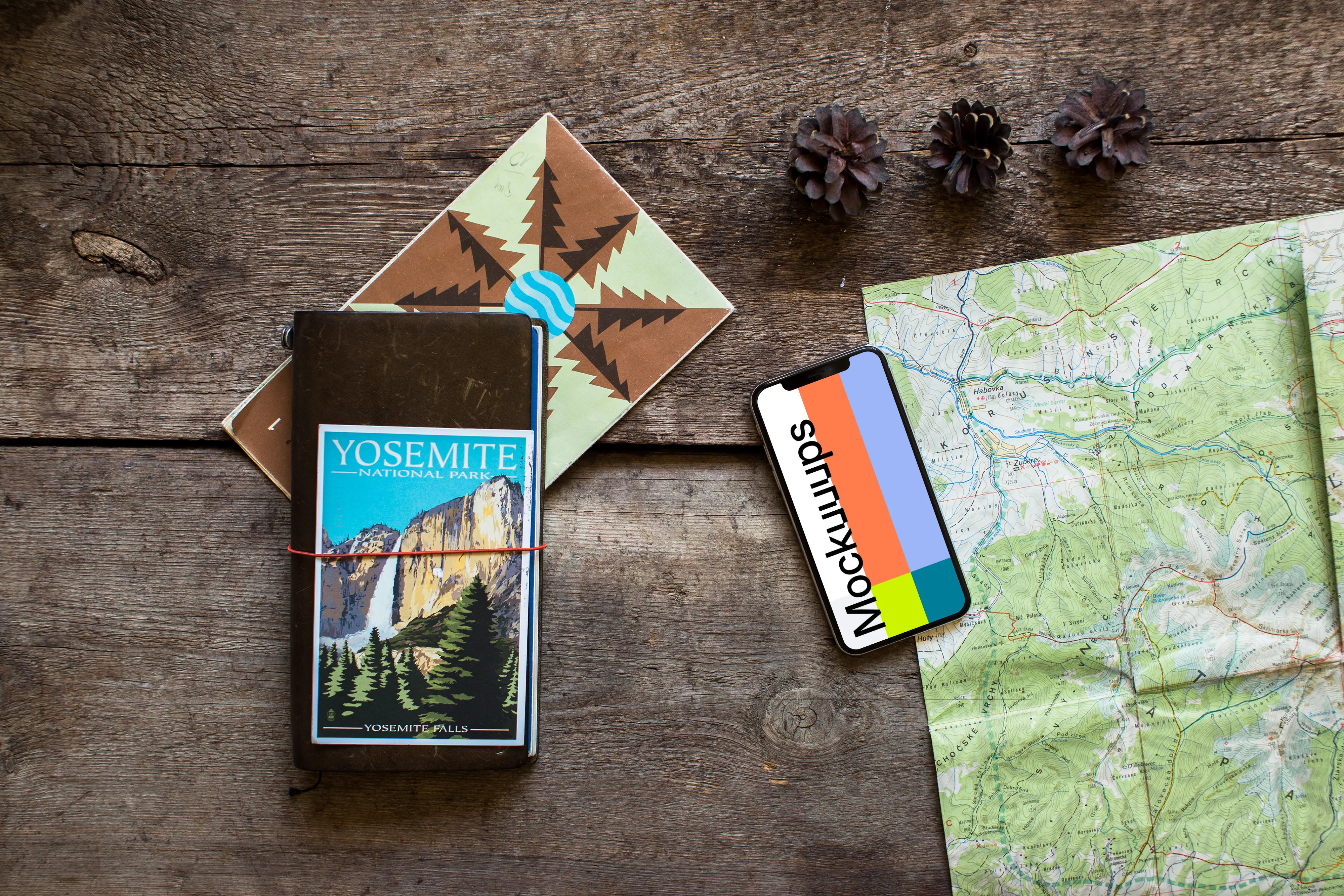 Rotated iPhone XS mockup with journal on the side