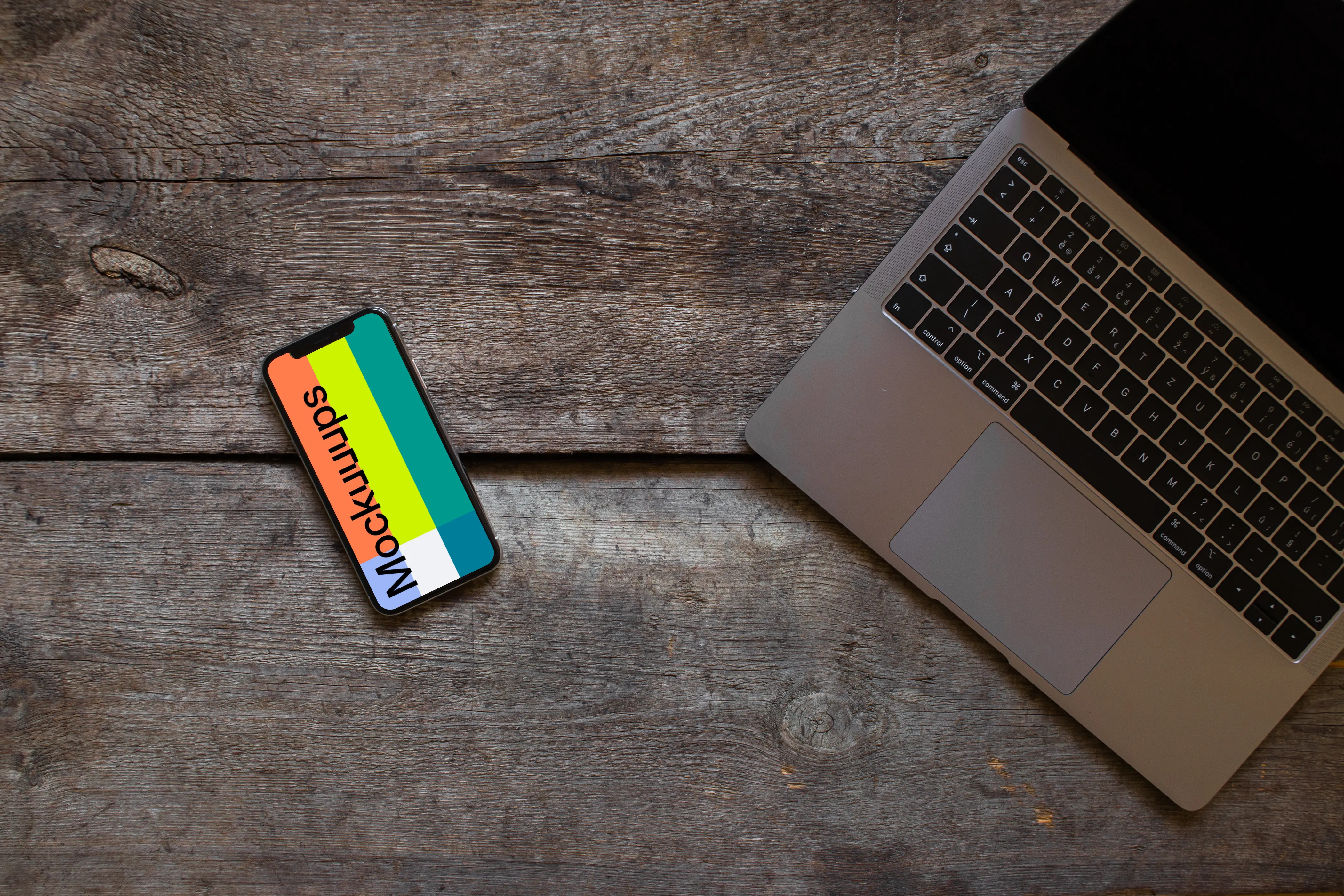 Rotated iPhone XS mockup with Macbook Air on the right side