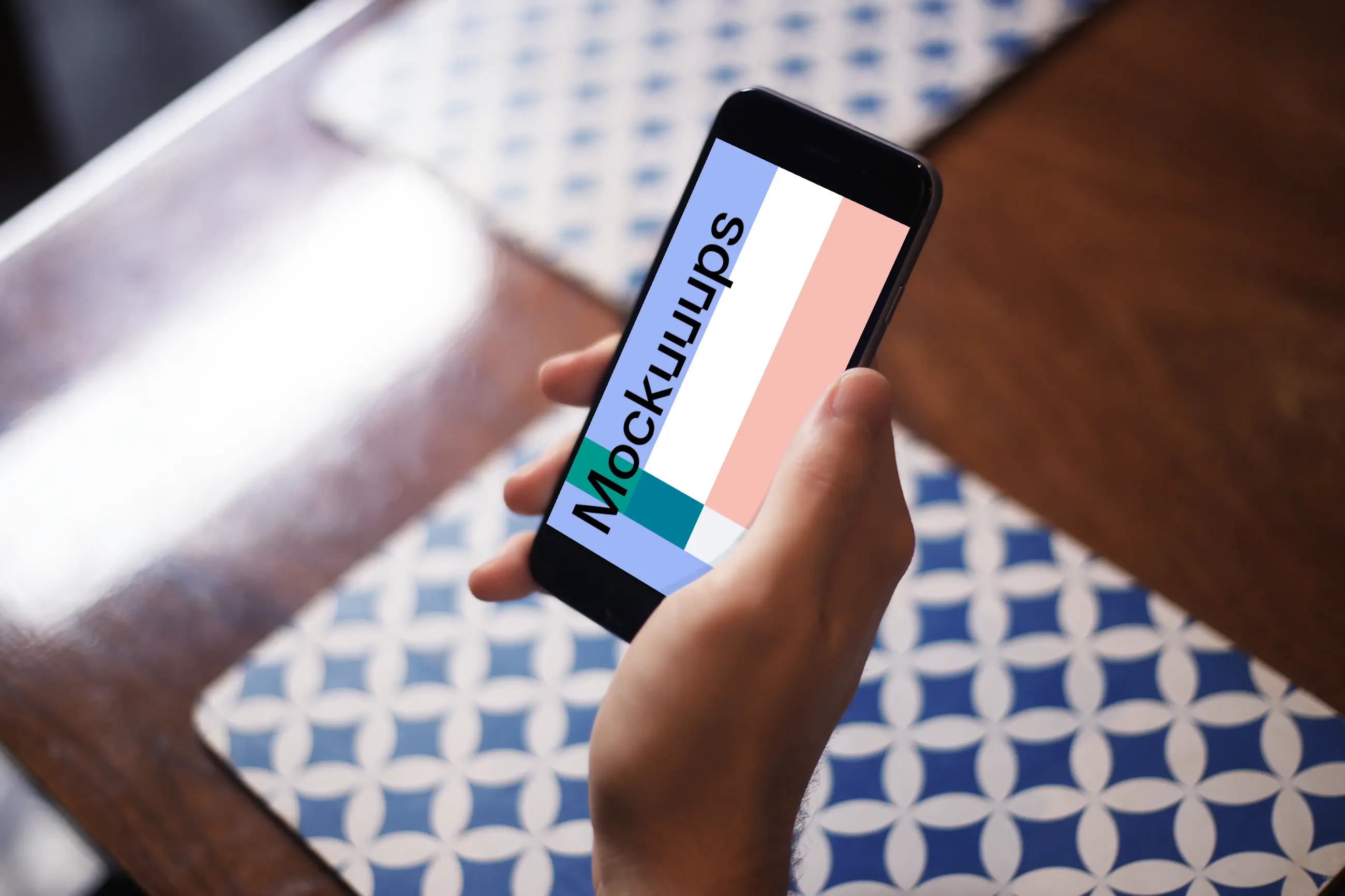 Sitting with iPhone 6 mockup at coffee