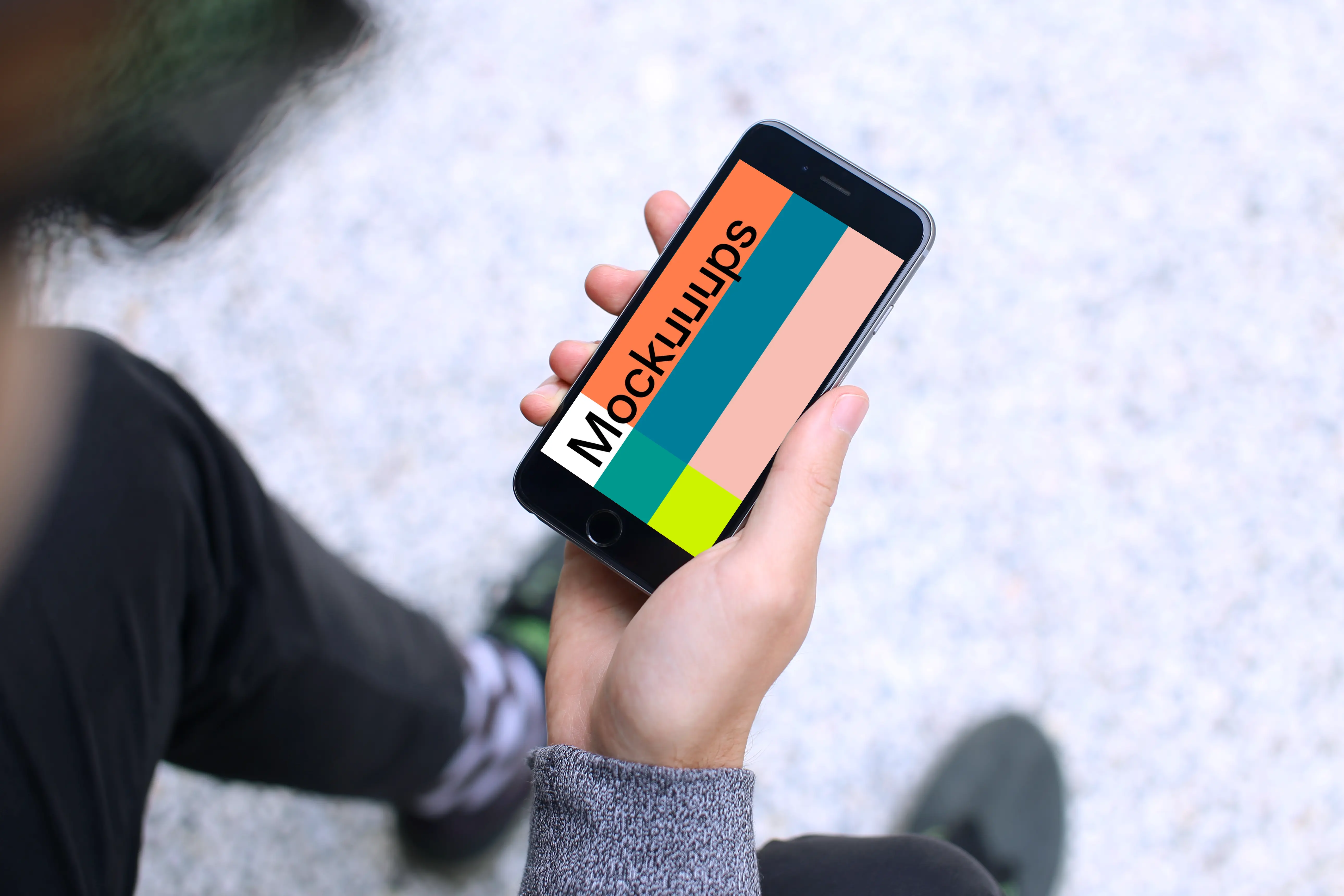 Sitting with iPhone 6s mockup Space Gray