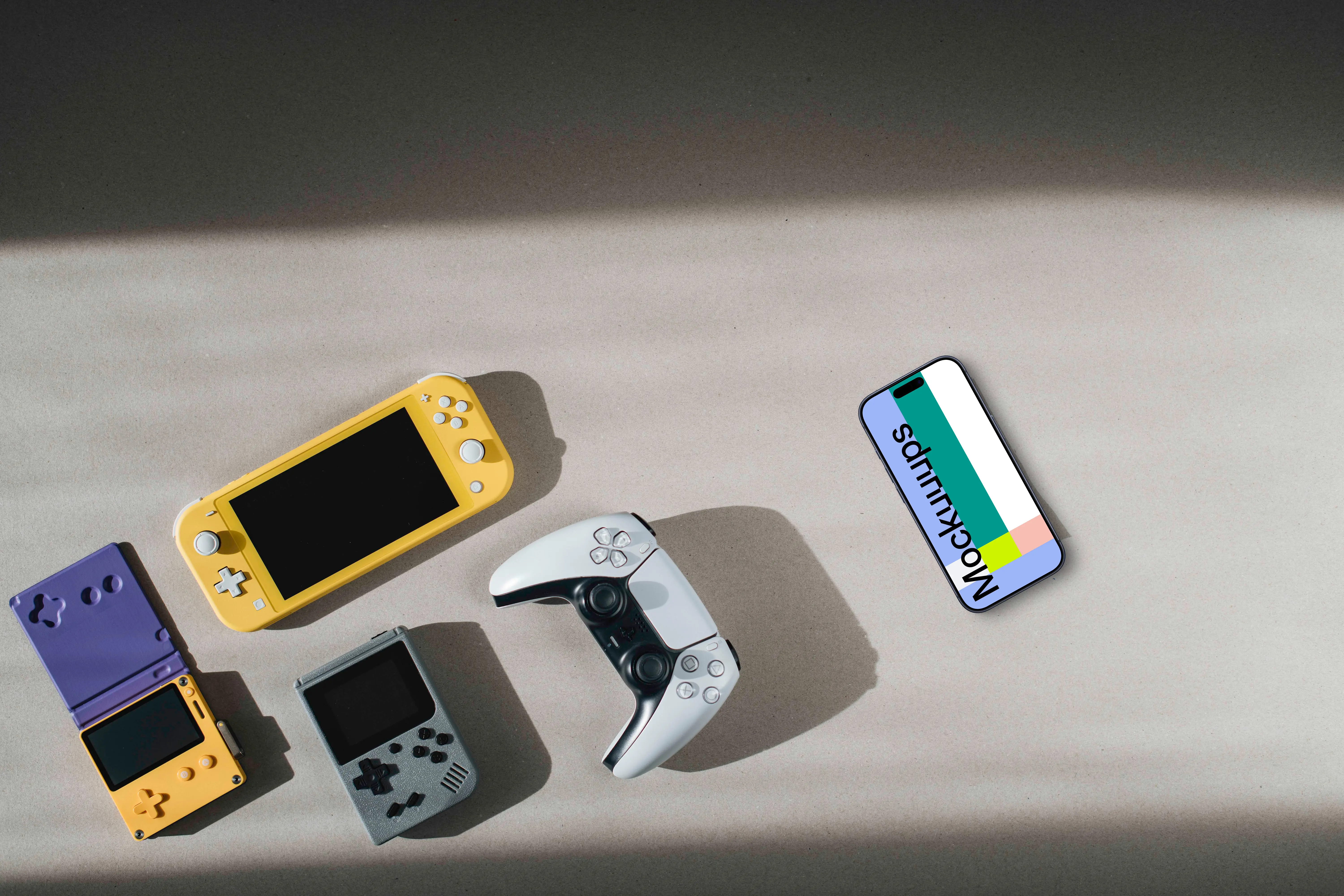 Smartphone mockup among gaming devices on neutral background