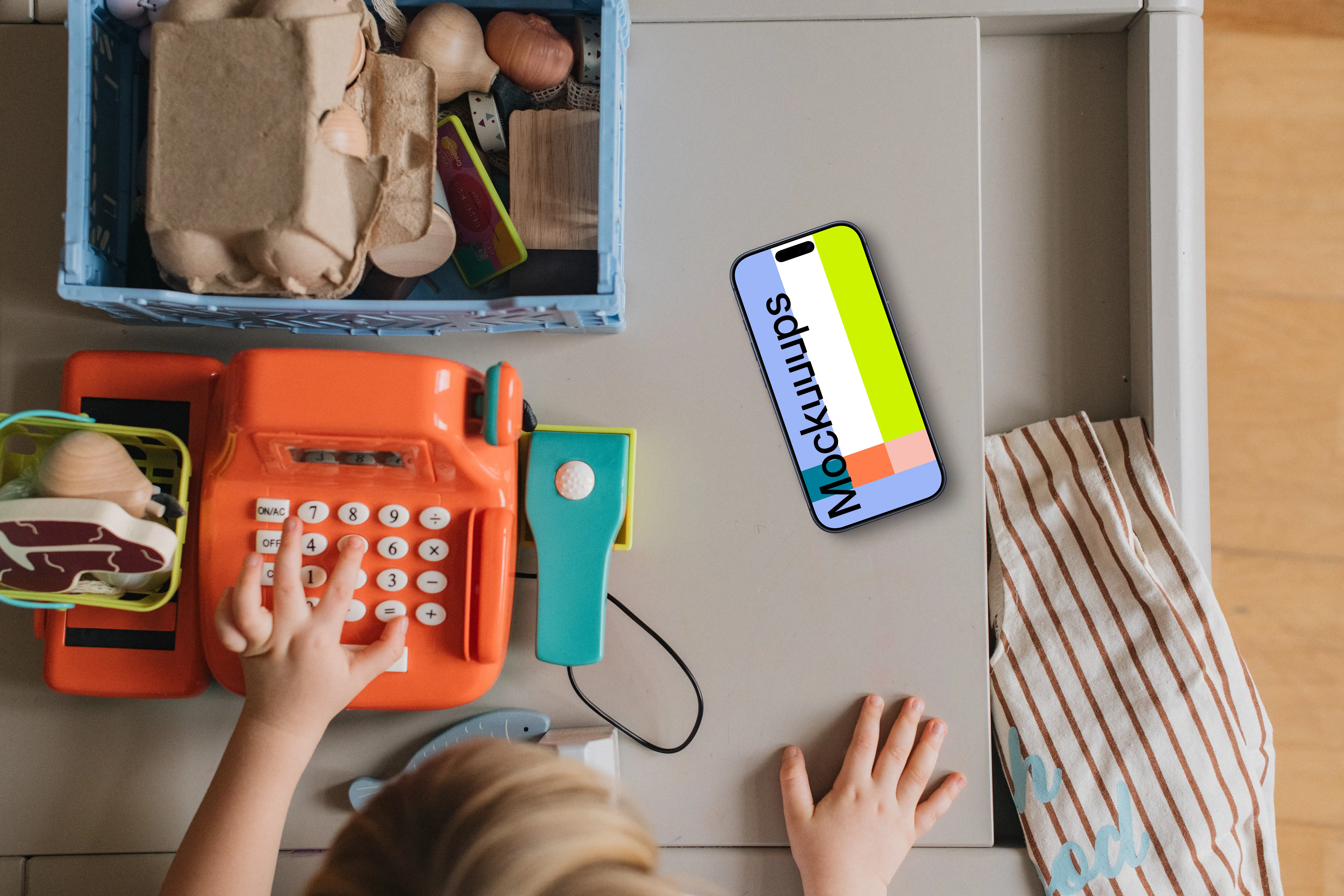 Smartphone mockup beside children's play area