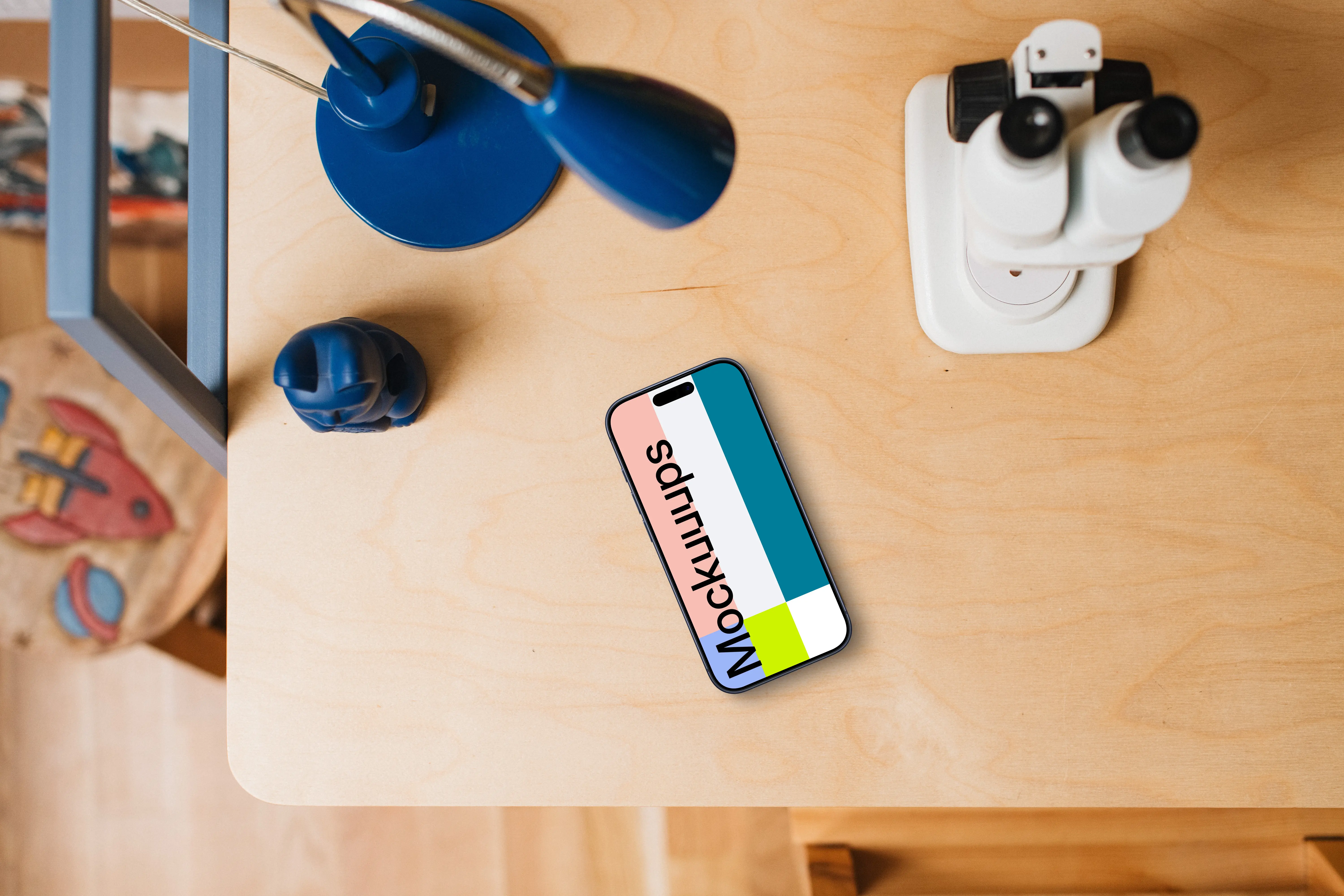 Smartphone mockup on a child's creative table