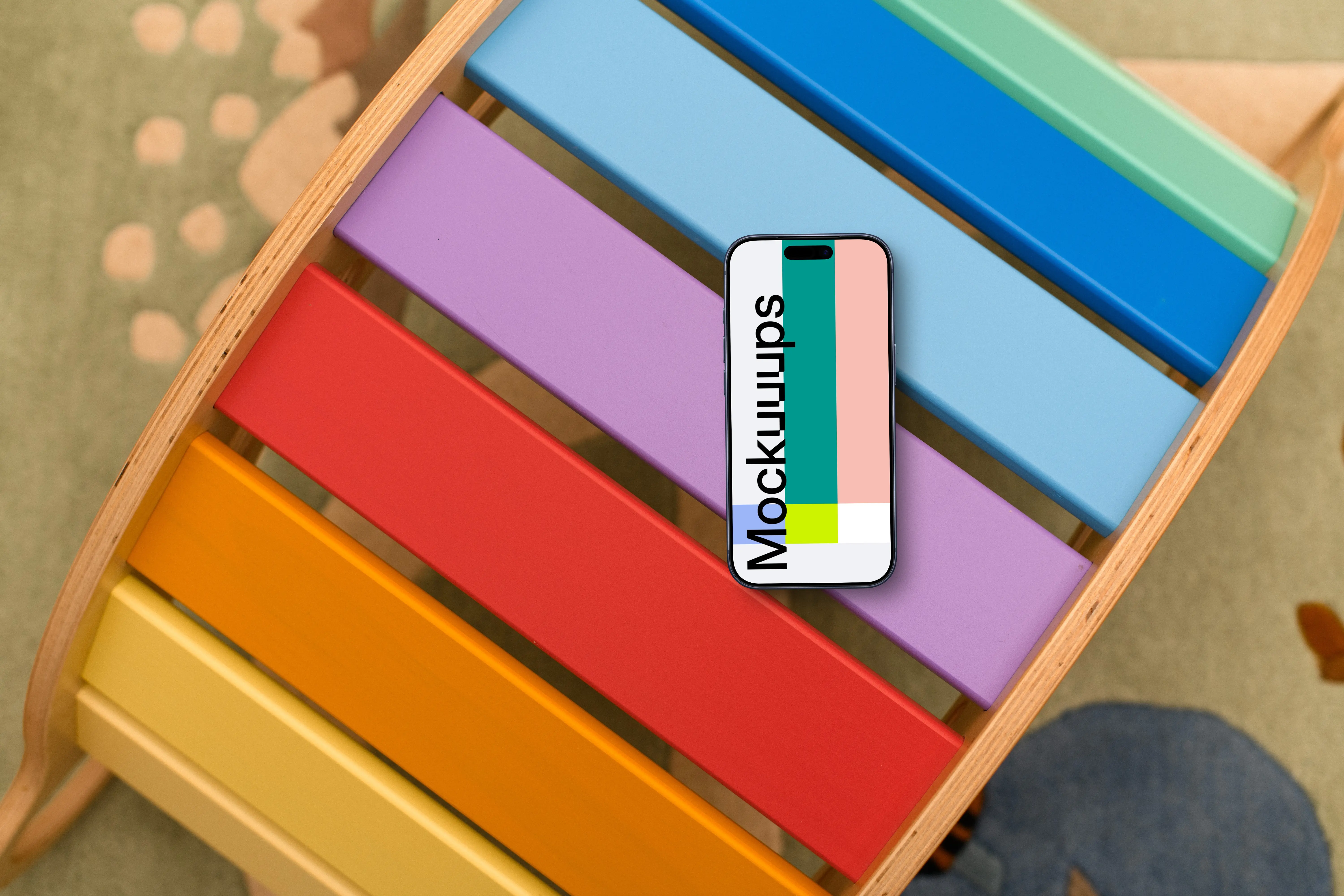 Smartphone mockup on colorful child's play table