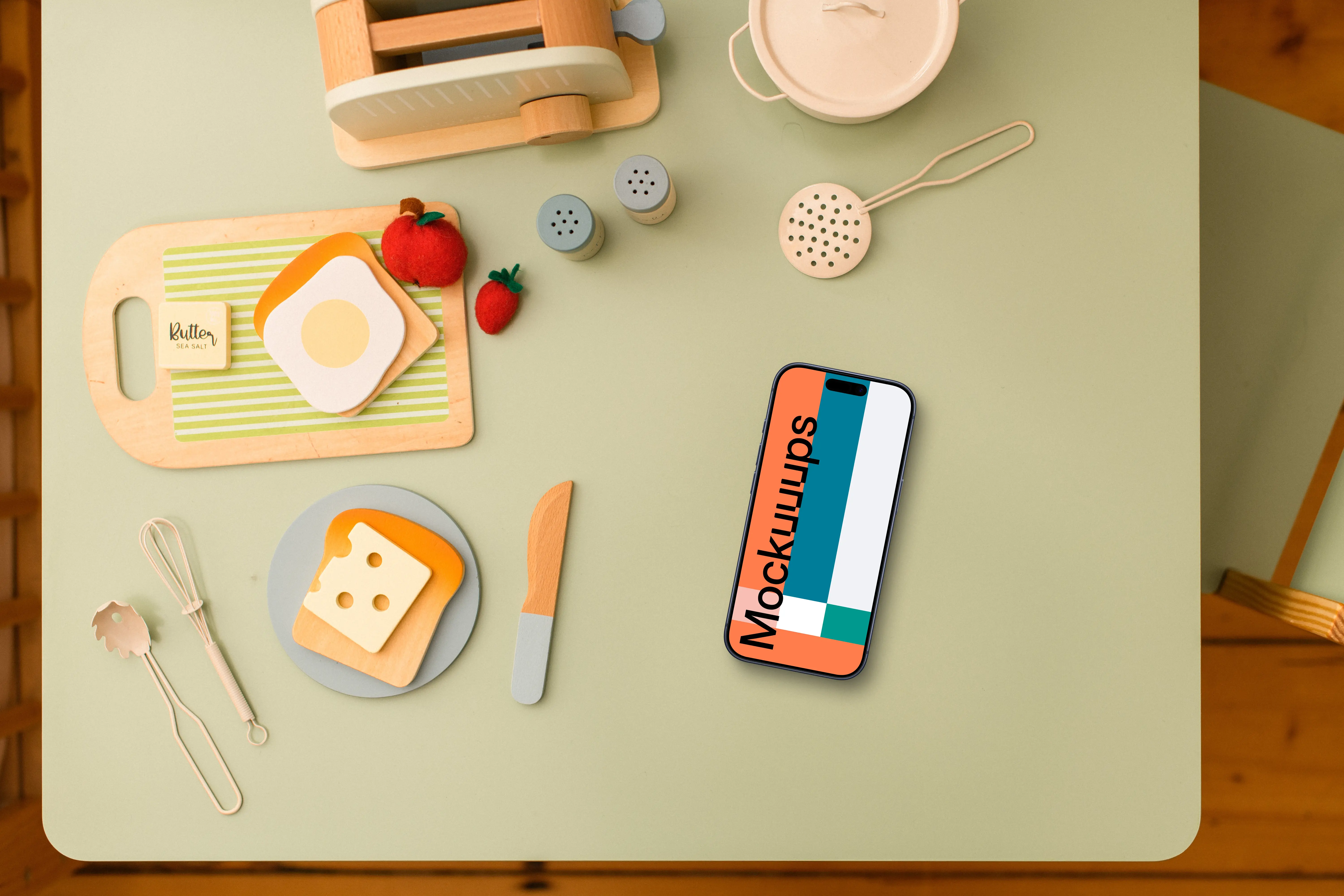 Smartphone mockup with children's play kitchen accessories