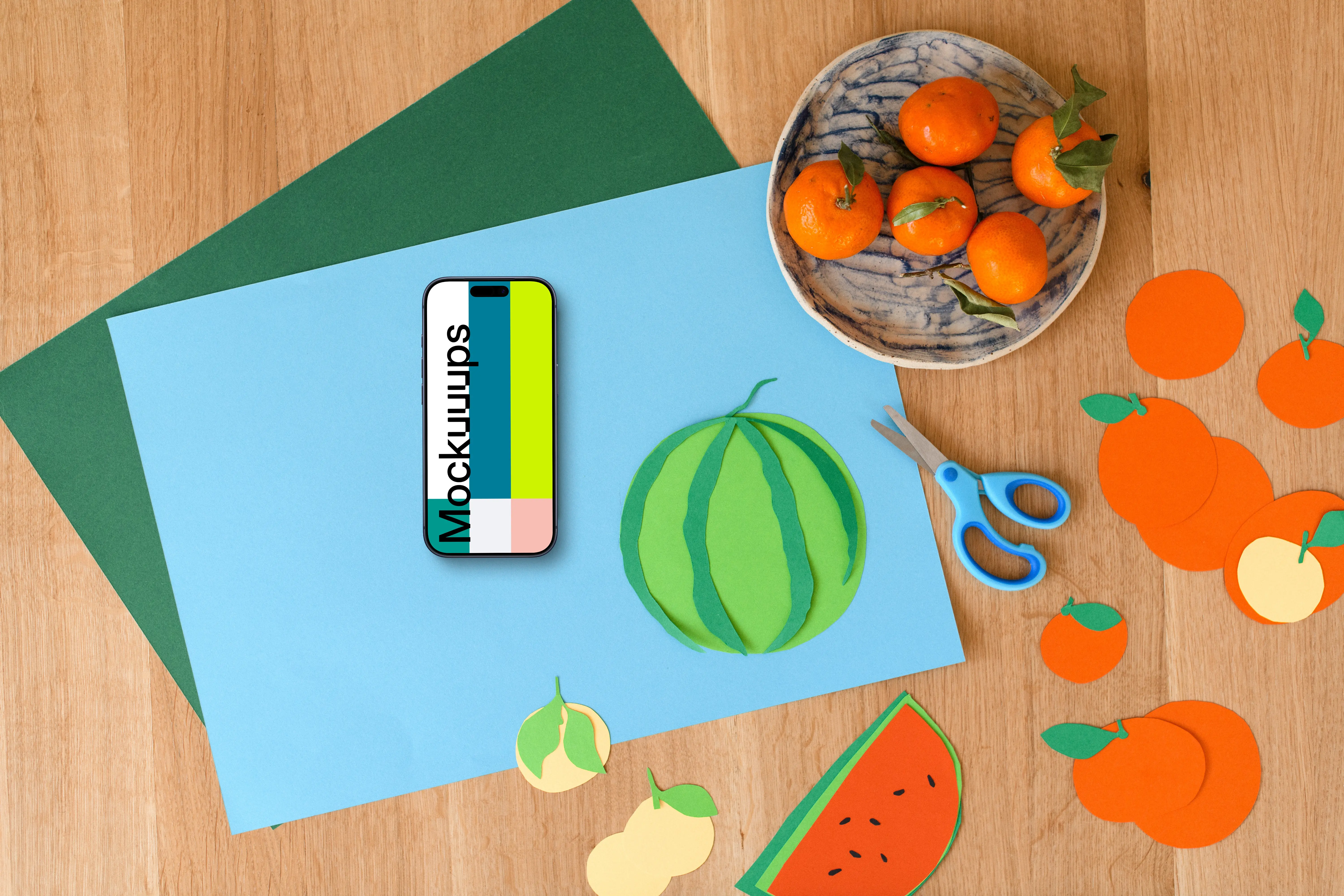 Smartphone mockup with colorful paper fruits on wooden surface