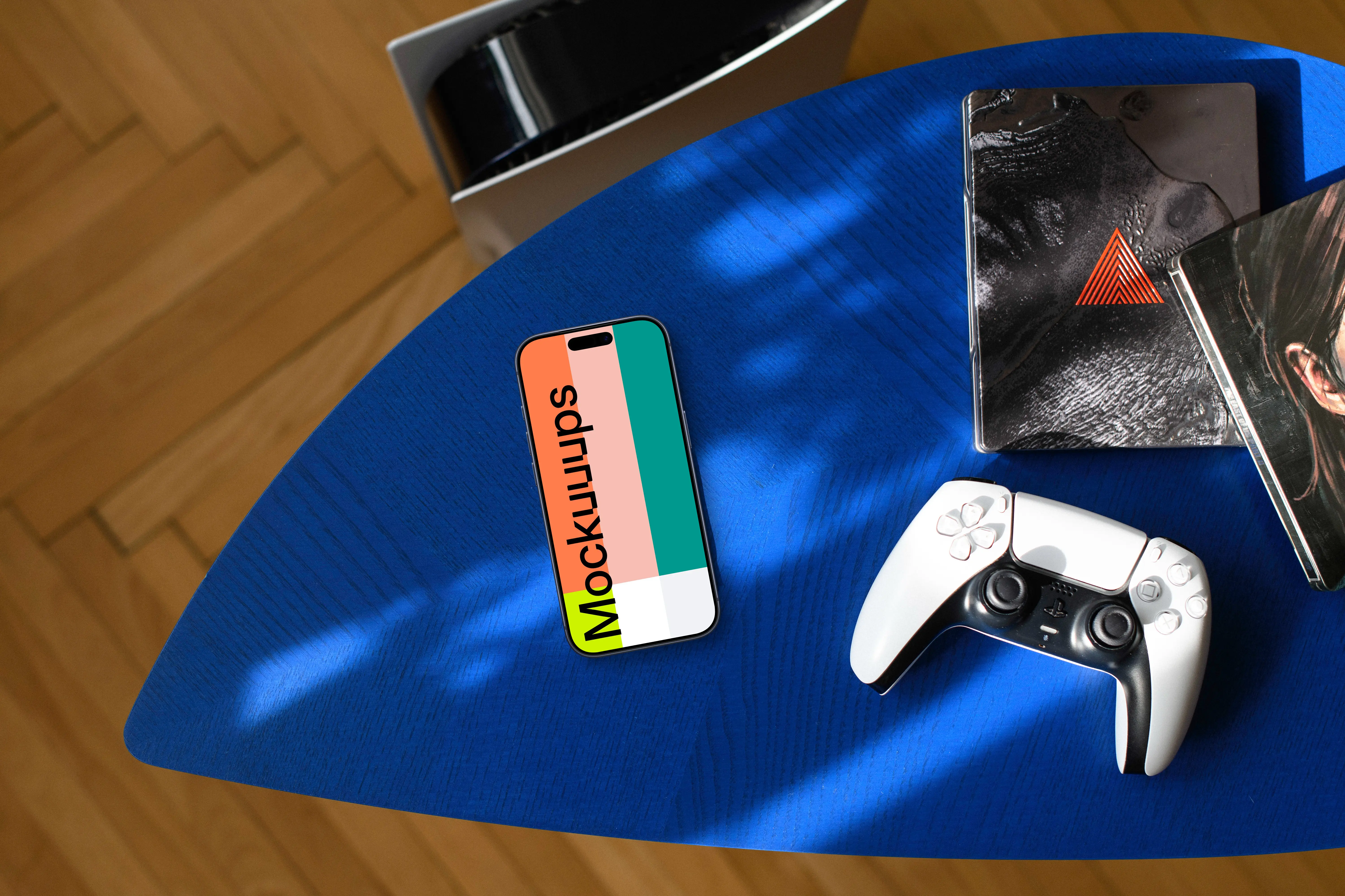 Smartphone mockup with gaming accessories on blue surface
