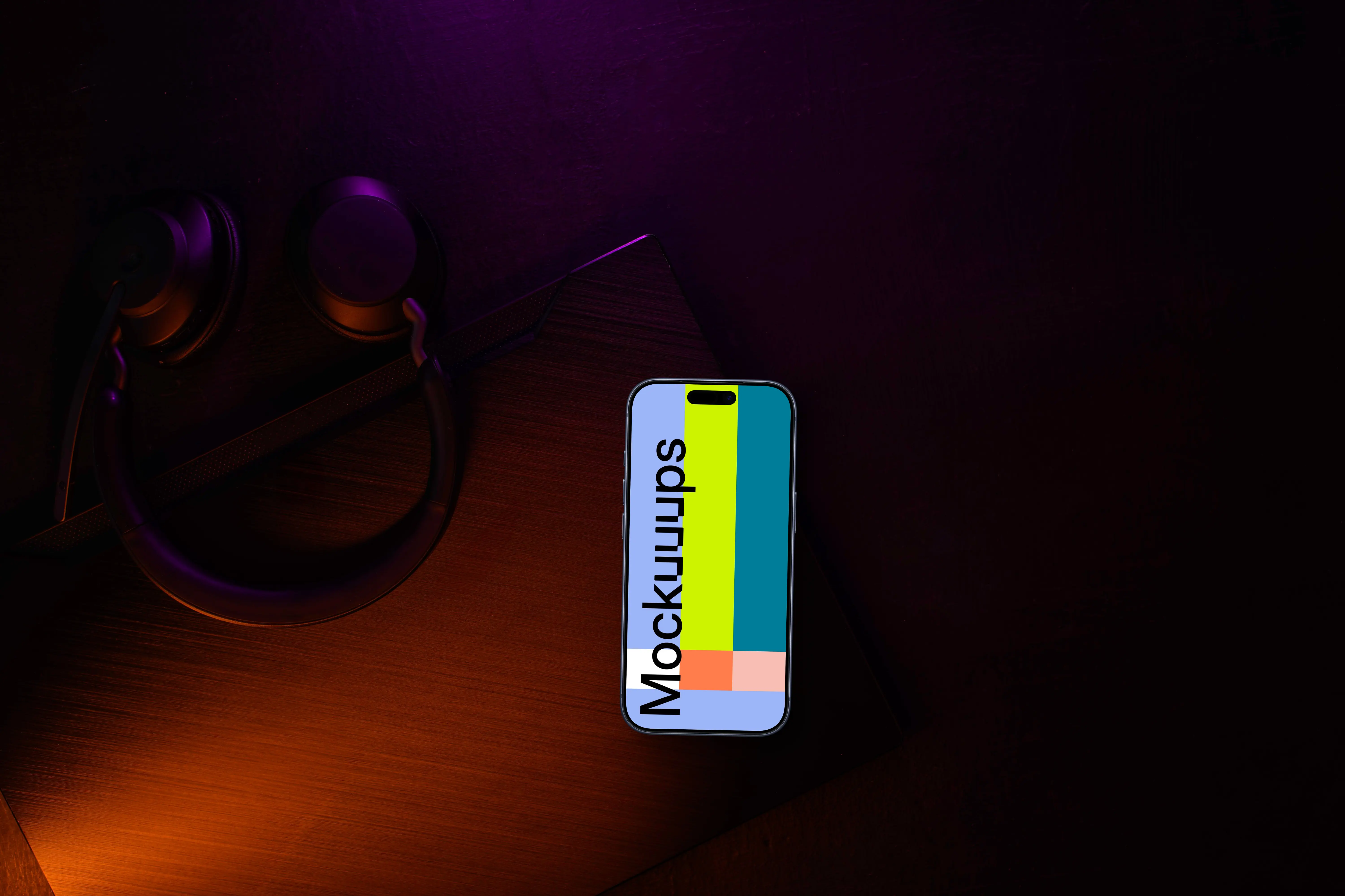 Smartphone mockup with headphones on dark desk