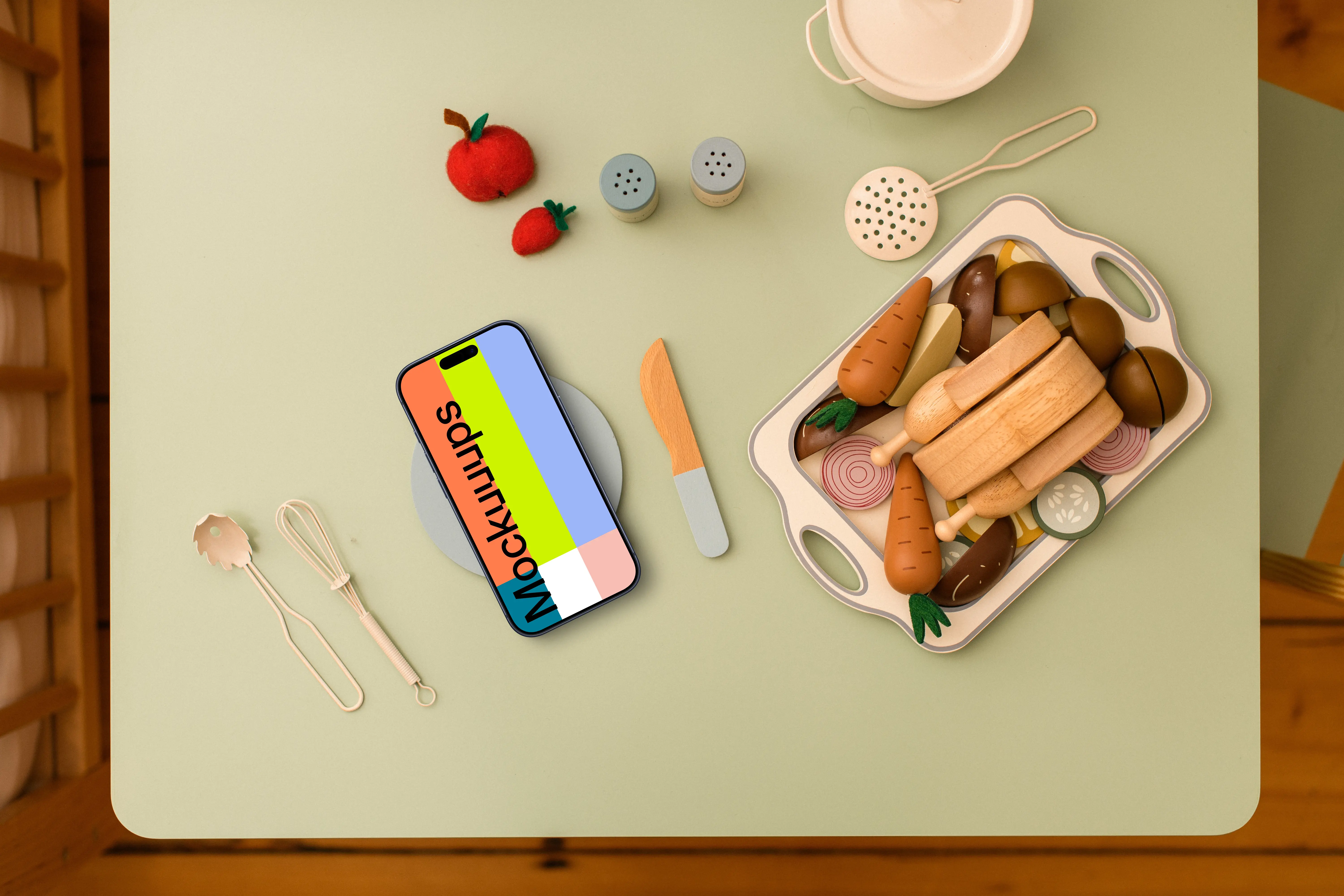 Smartphone mockup with playful wooden toy kitchen accessories
