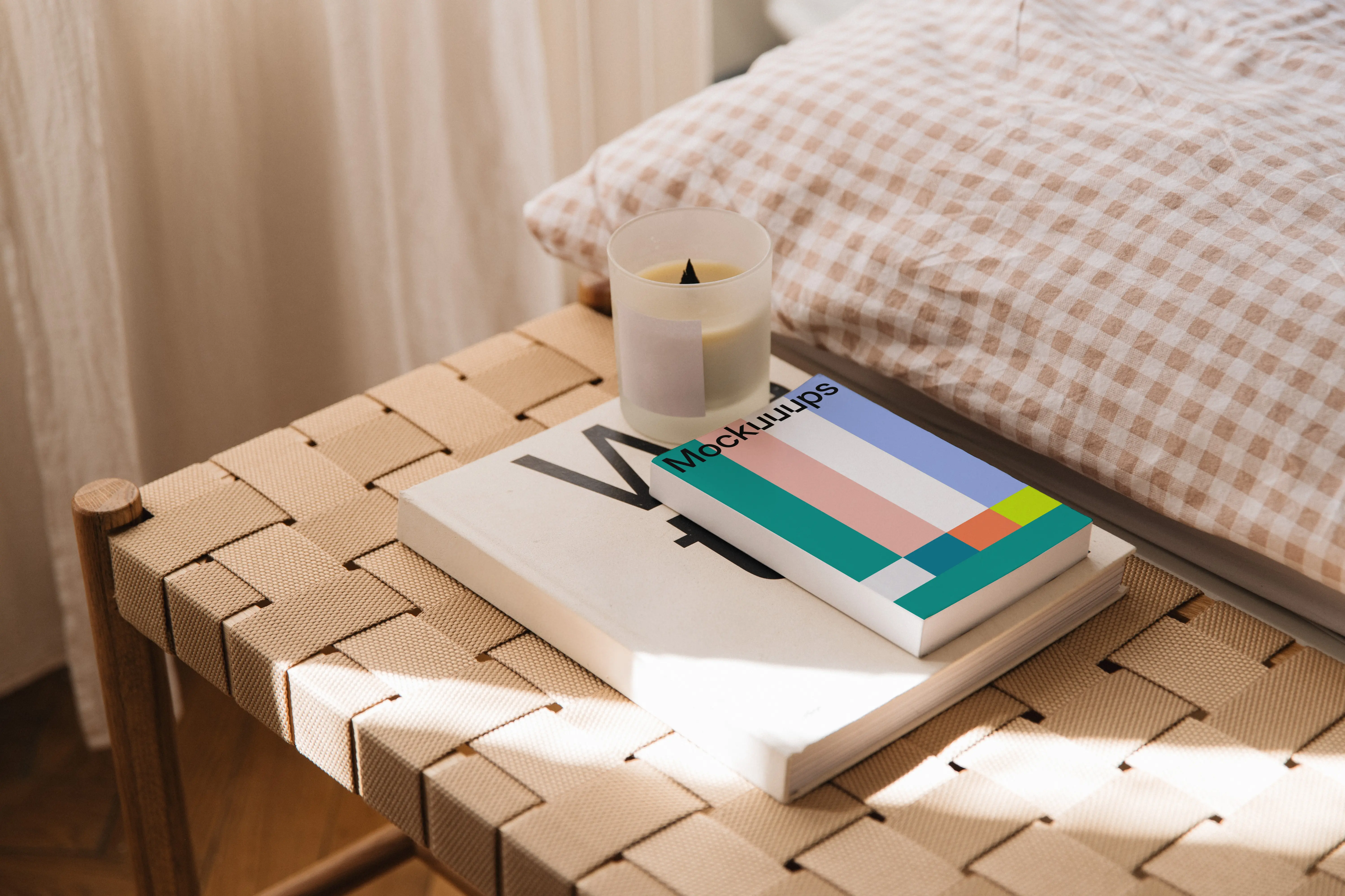 Softcover book mockup on a woven bench in natural light