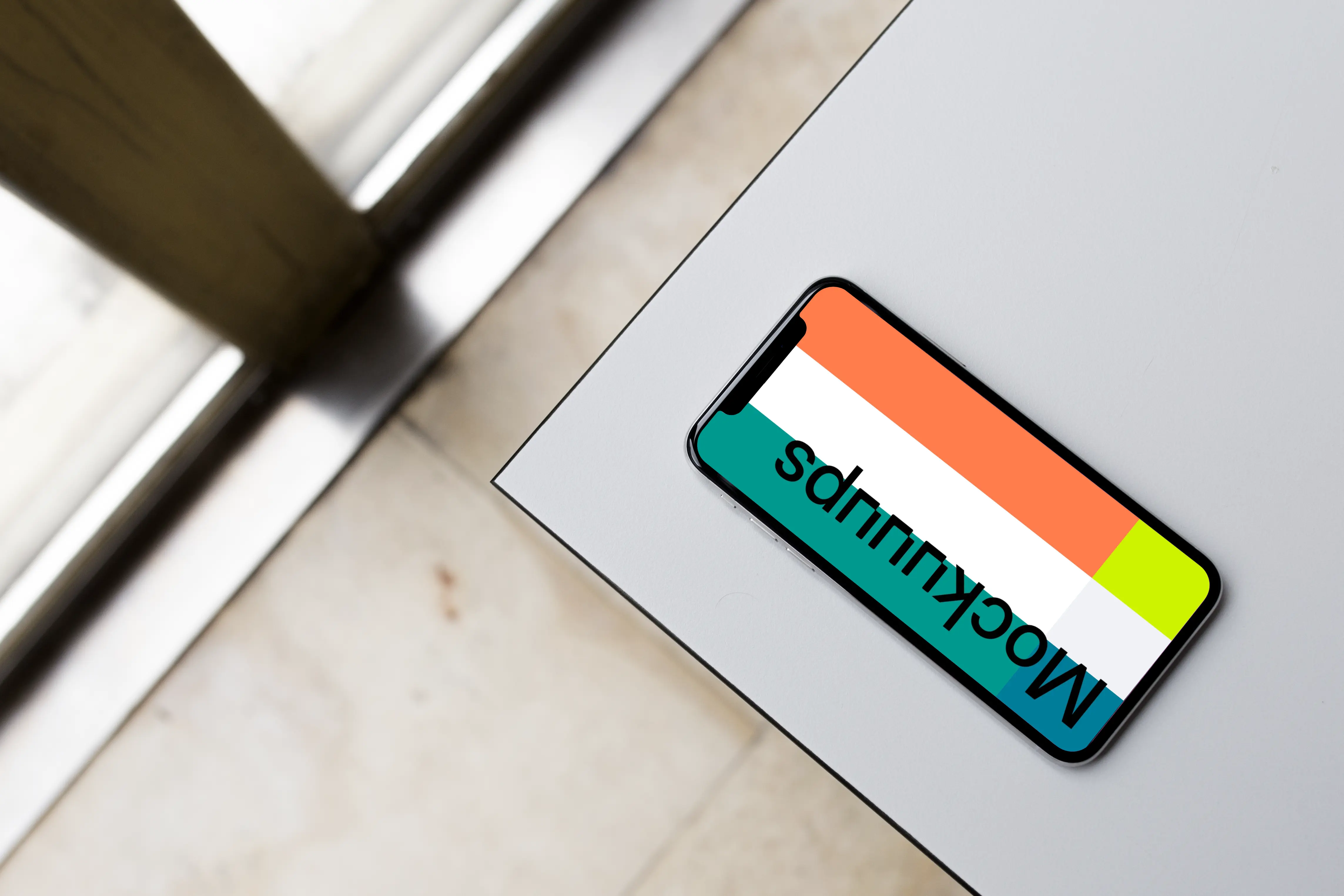 Top view mockup of iPhone X on the gray table