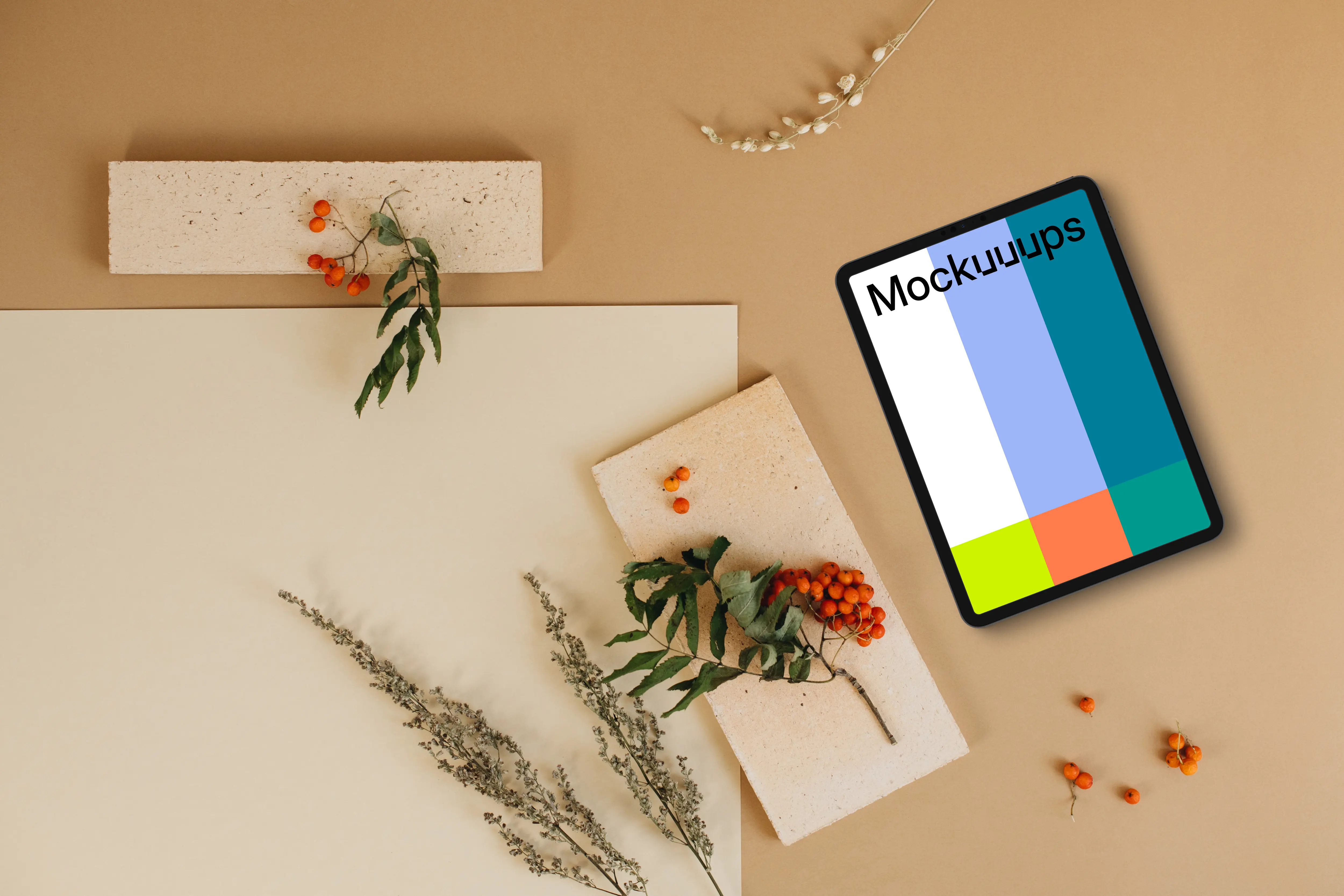 Top view of tablet mockup next to the blank paper