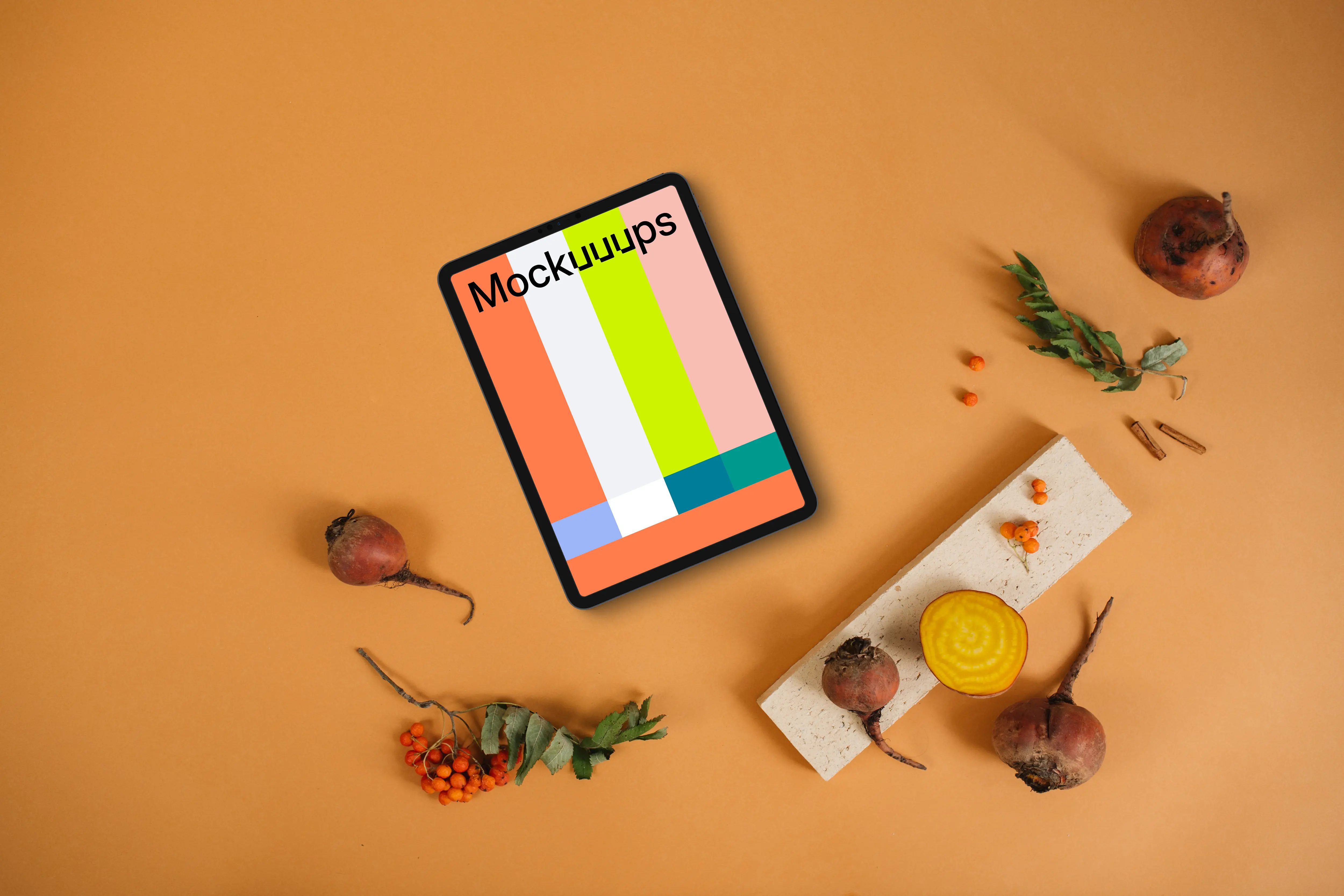 Top view of tablet mockup on the light orange background