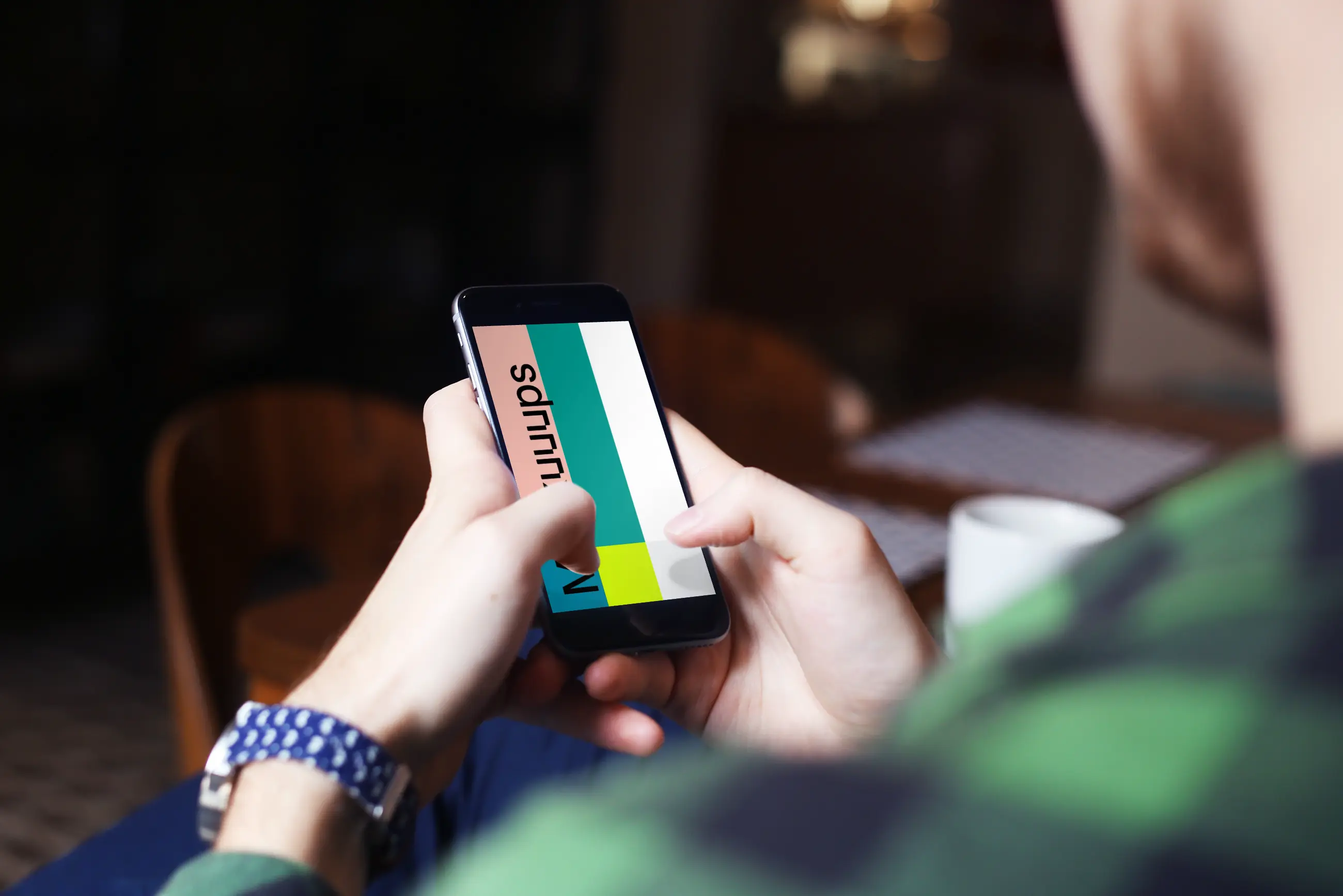 Typing on iPhone 6 mockup screen at coffee