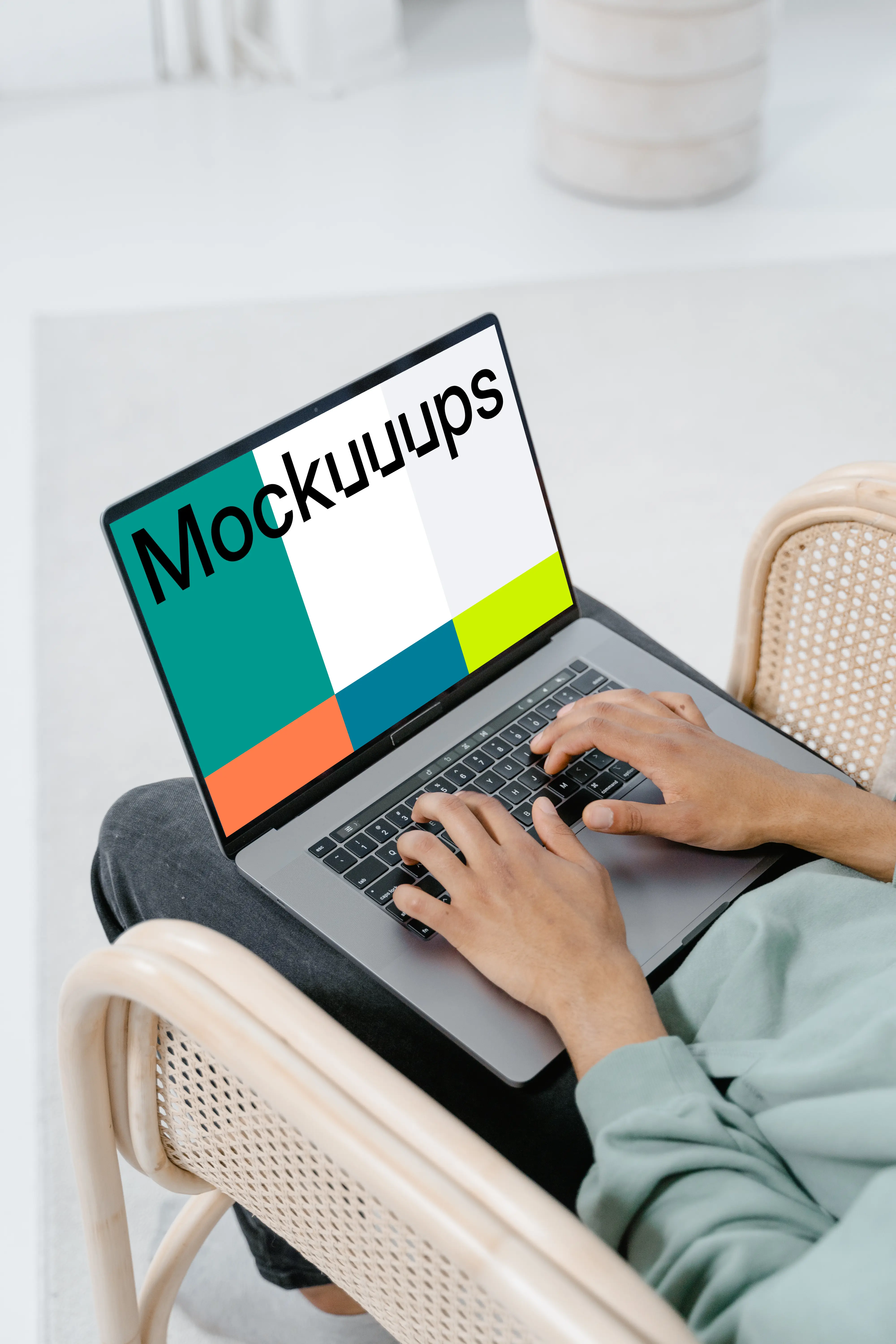 User typing on a MacBook mockup
