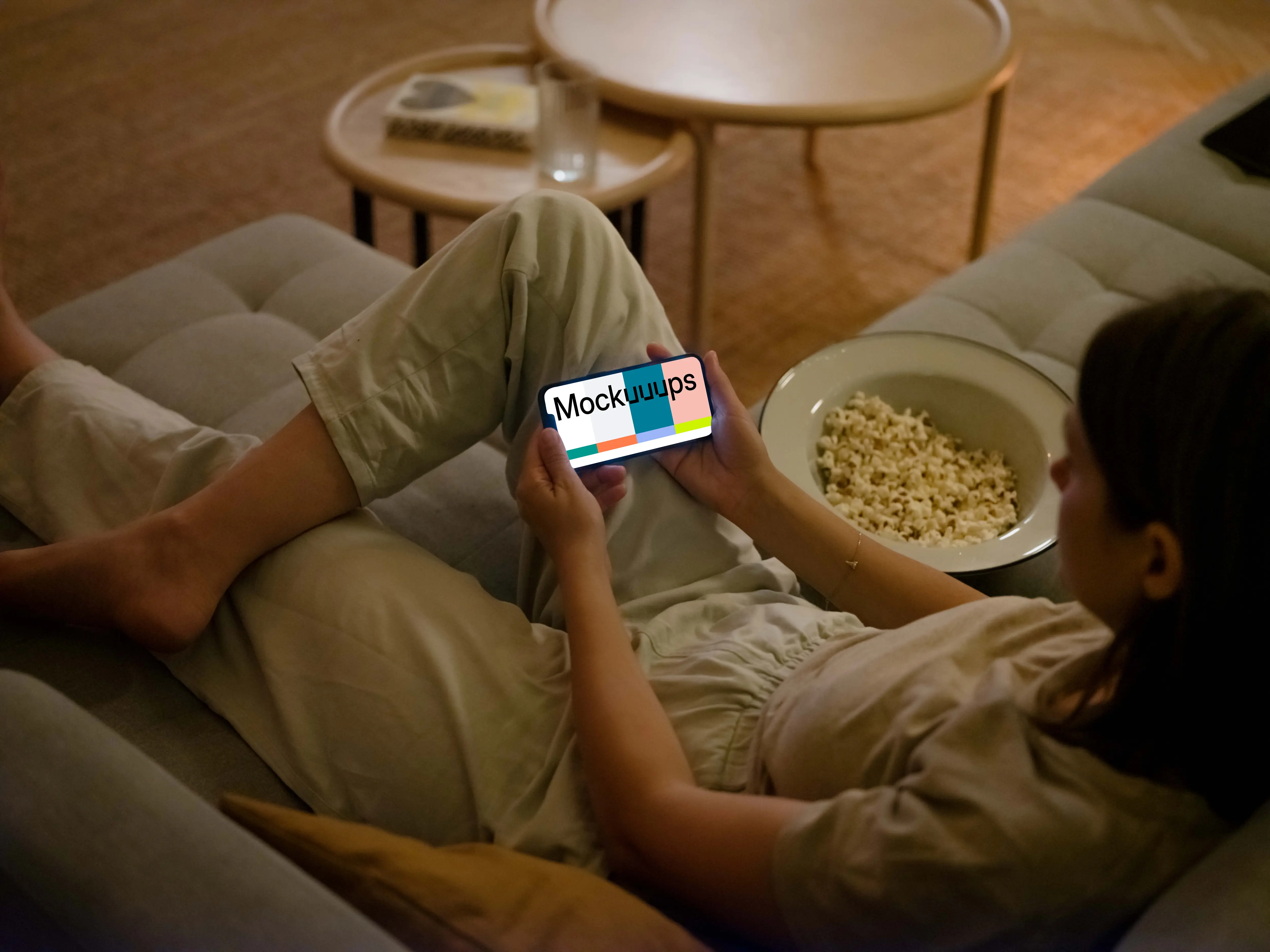 Woman holding an iPhone mockup