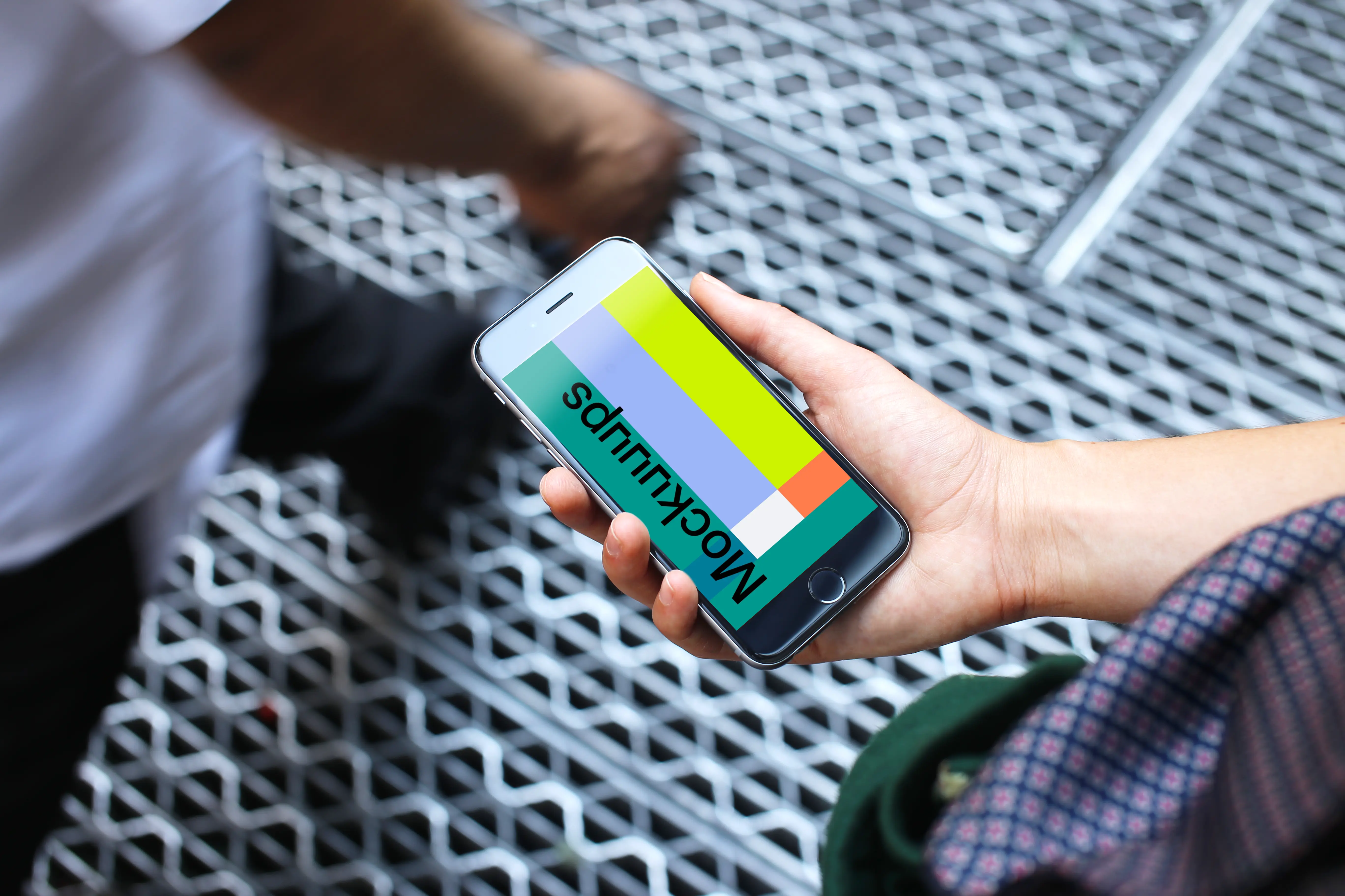 Woman holding iPhone 6s mockup on a bridge