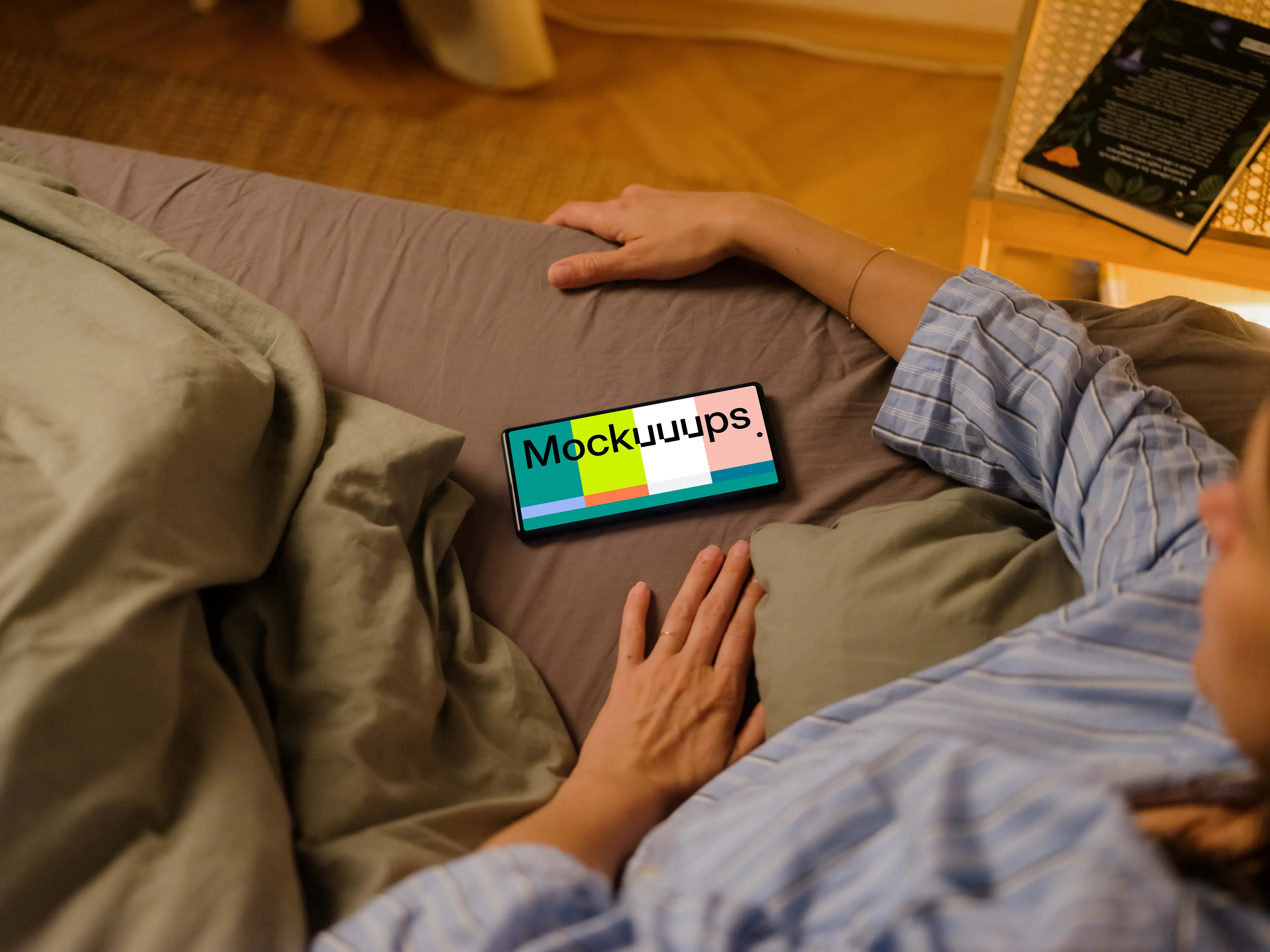 Woman laying in bed next to the Google Pixel 6 mockup