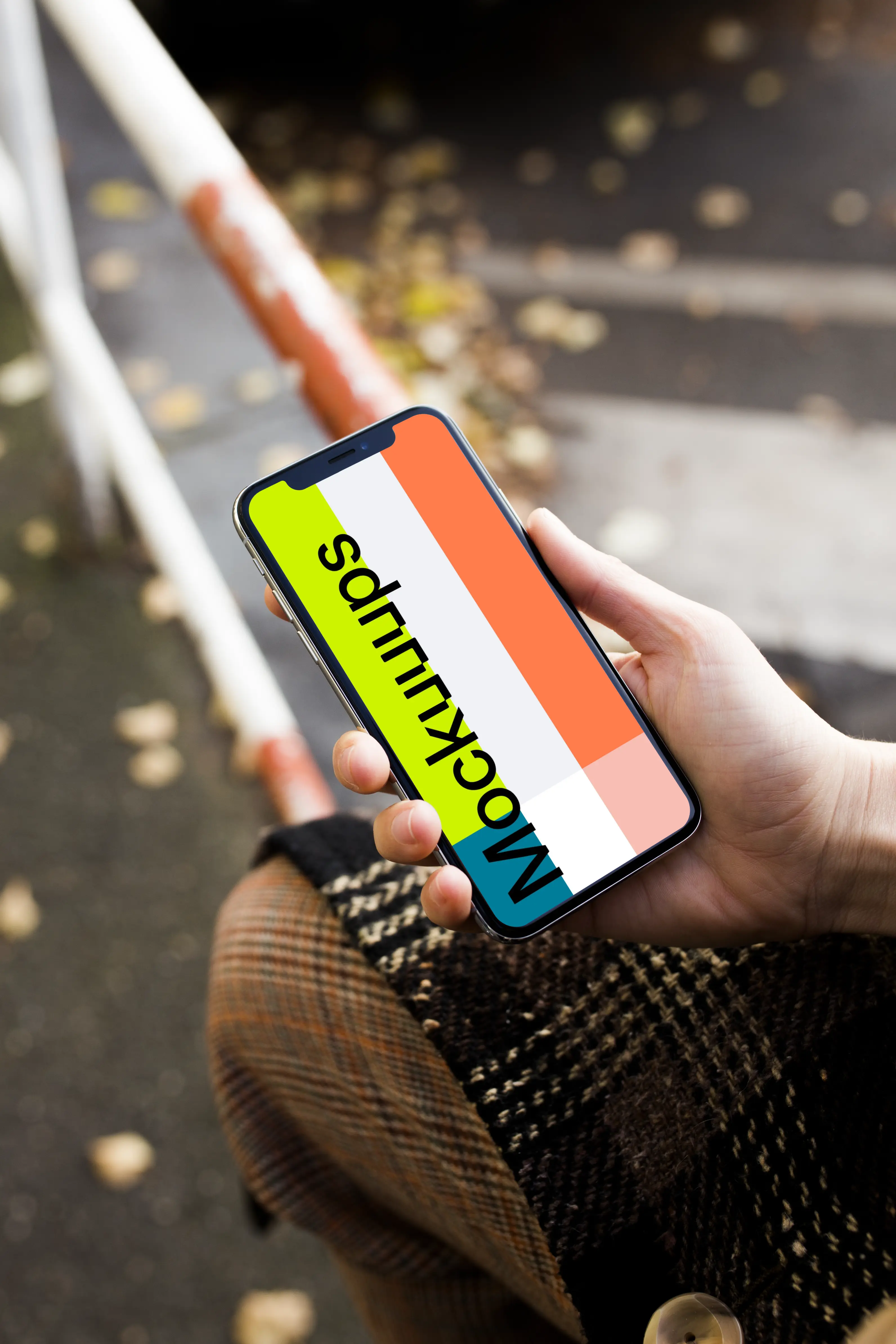 Woman sitting and holding iPhone X mockup