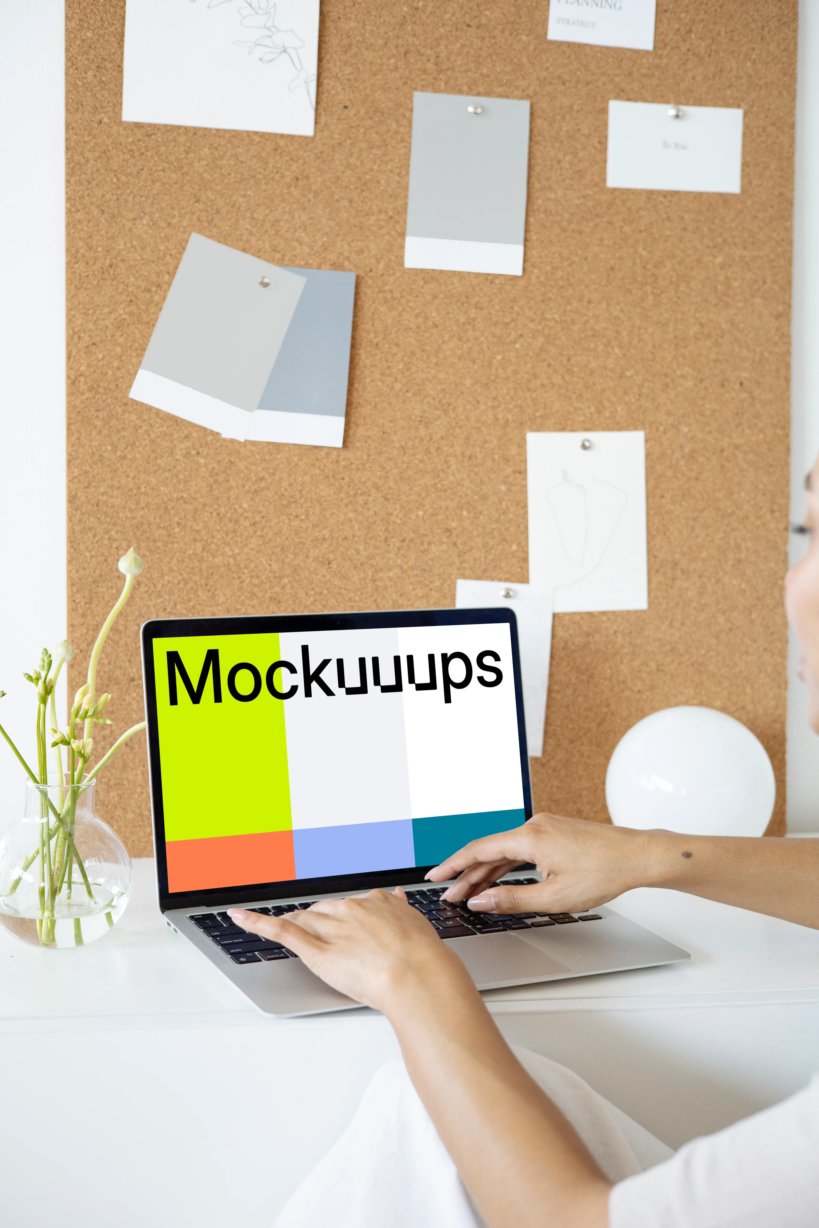 Woman using a MacBook Pro mockup in front of a bulletin board